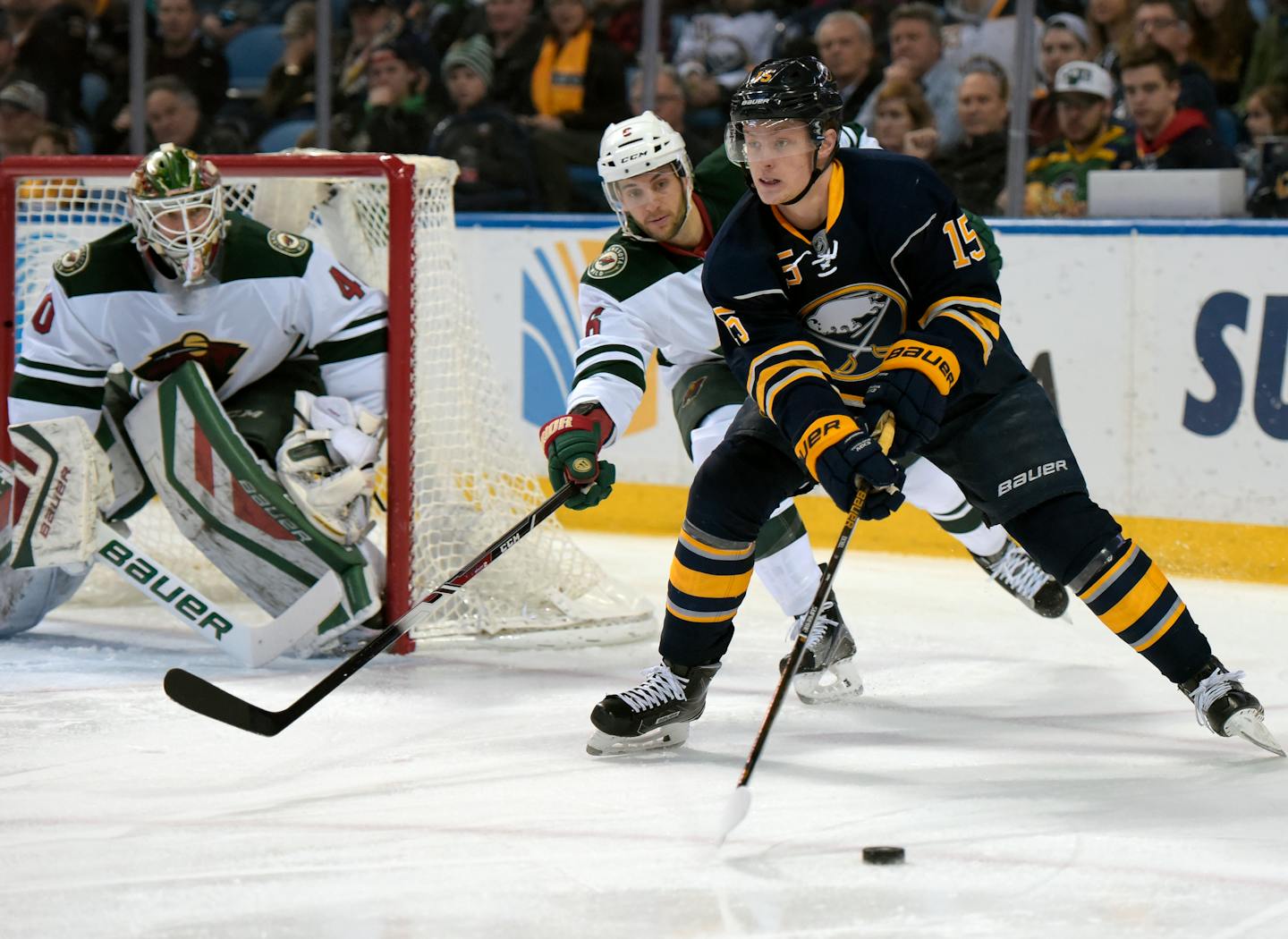 Minnesota Wild goaltender Devan Dubnyk (40) and defenseman Marco Scandella (6) defend as Buffalo Sabres center Jack Eichel (15) looks to pass the puck during the first period of an NHL hockey game, Saturday, March 5, 2016, in Buffalo, N.Y. (AP Photo/Gary Wiepert)