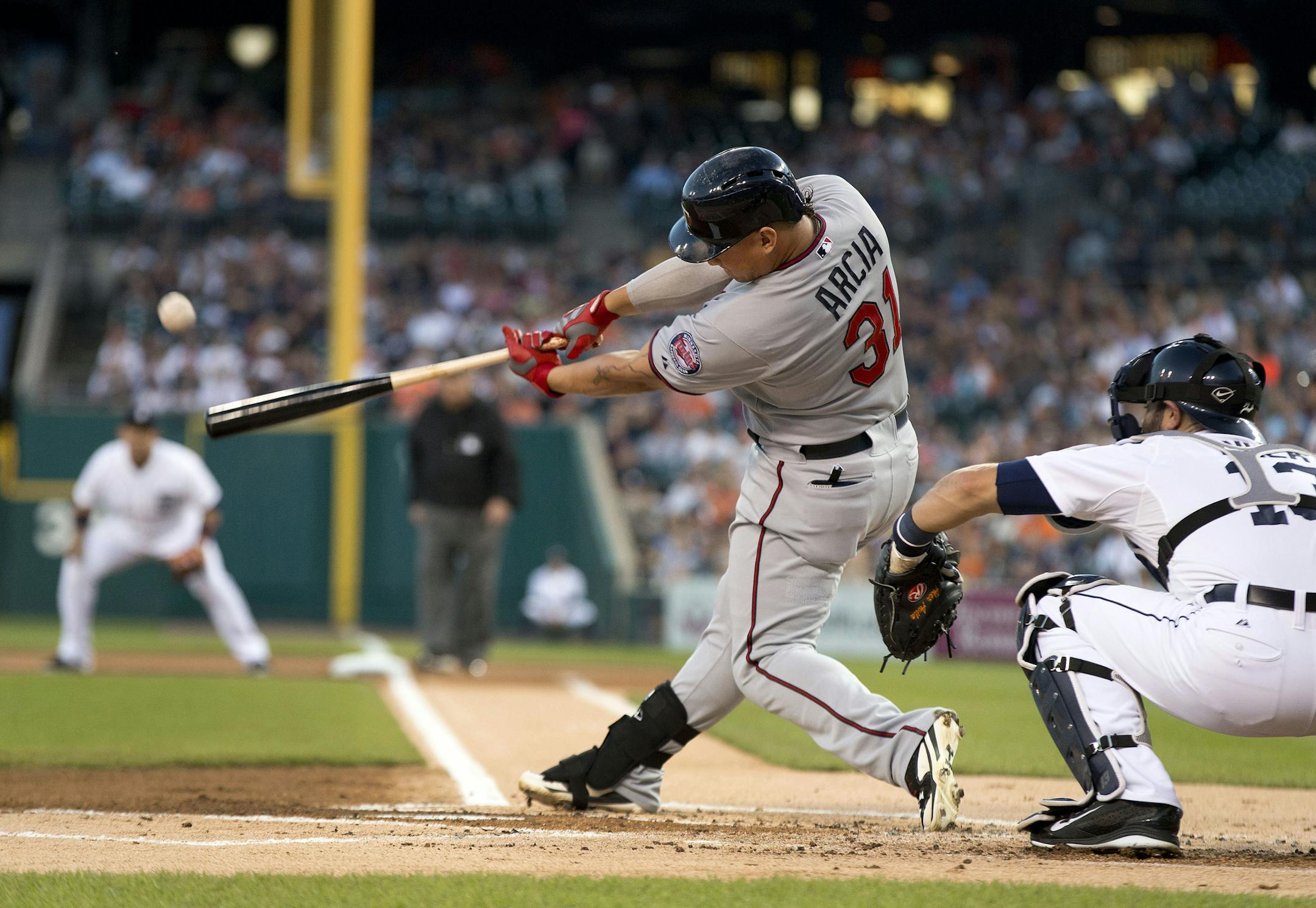 Minnesota Twins' Oswaldo Arcia hits a two-run home run off Detroit Tigers pitcher Rick Porcello in the the first inning of a baseball game in Detroit, Friday, Sept. 26, 2014. (AP Photo/Paul Sancya)