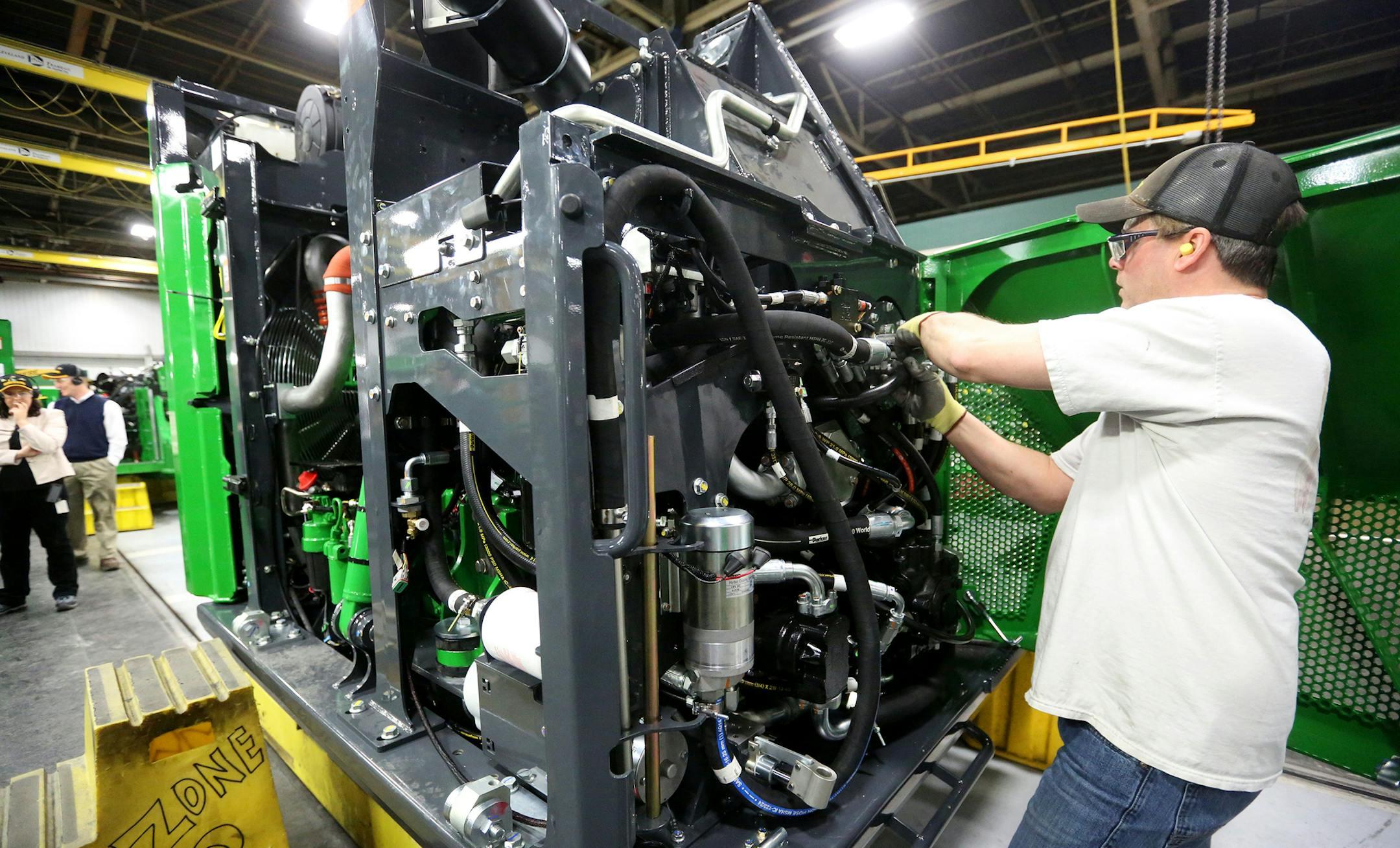 FILE - In this Feb. 11, 2015, file photo, Mark Moriarty works on a John Deere Tracked Feller Buncher/Harvester at John Deere Dubuque Works in Dubuque, Iowa. The Commerce Department reports on U.S. factory orders for June 2015 on Tuesday, Aug. 4, 2015. (Jessica Reilly/Telegraph Herald via AP) MANDATORY CREDIT ORG XMIT: MIN2015080711582621