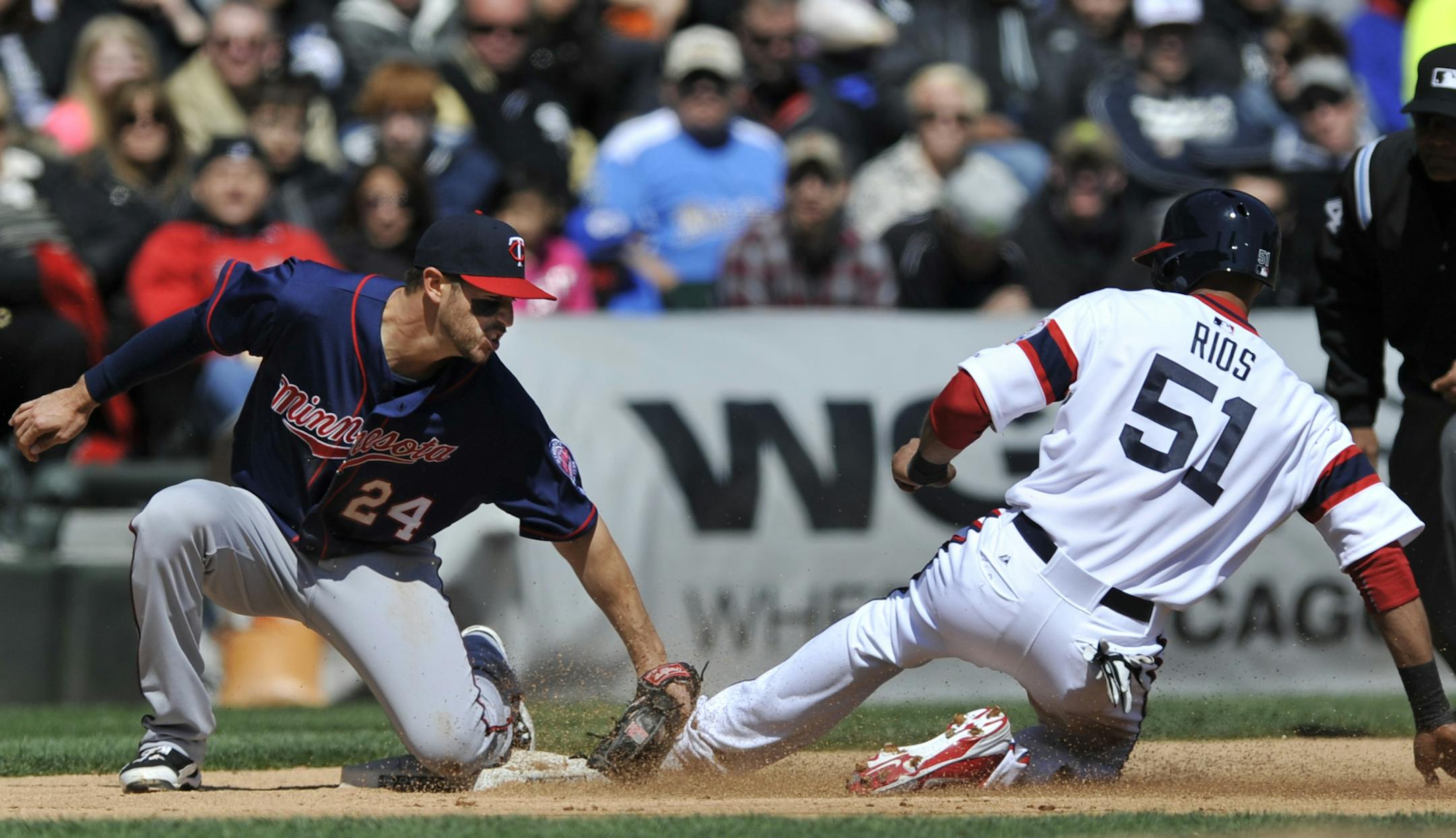 Chicago White Sox's Alex Rios (51) gets tagged out by Minnesota Twins third baseman Trevor Plouffe after trying to steal third base during the fourth inning of a baseball game in Chicago, April 21, 2013. Minnesota won 5-3. (AP Photo/Paul Beaty)