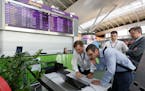 Airport employees work use a laptop computer at Boryspil airport in Kiev, Ukraine, Tuesday, June 27, 2017. A new and highly virulent outbreak of malic