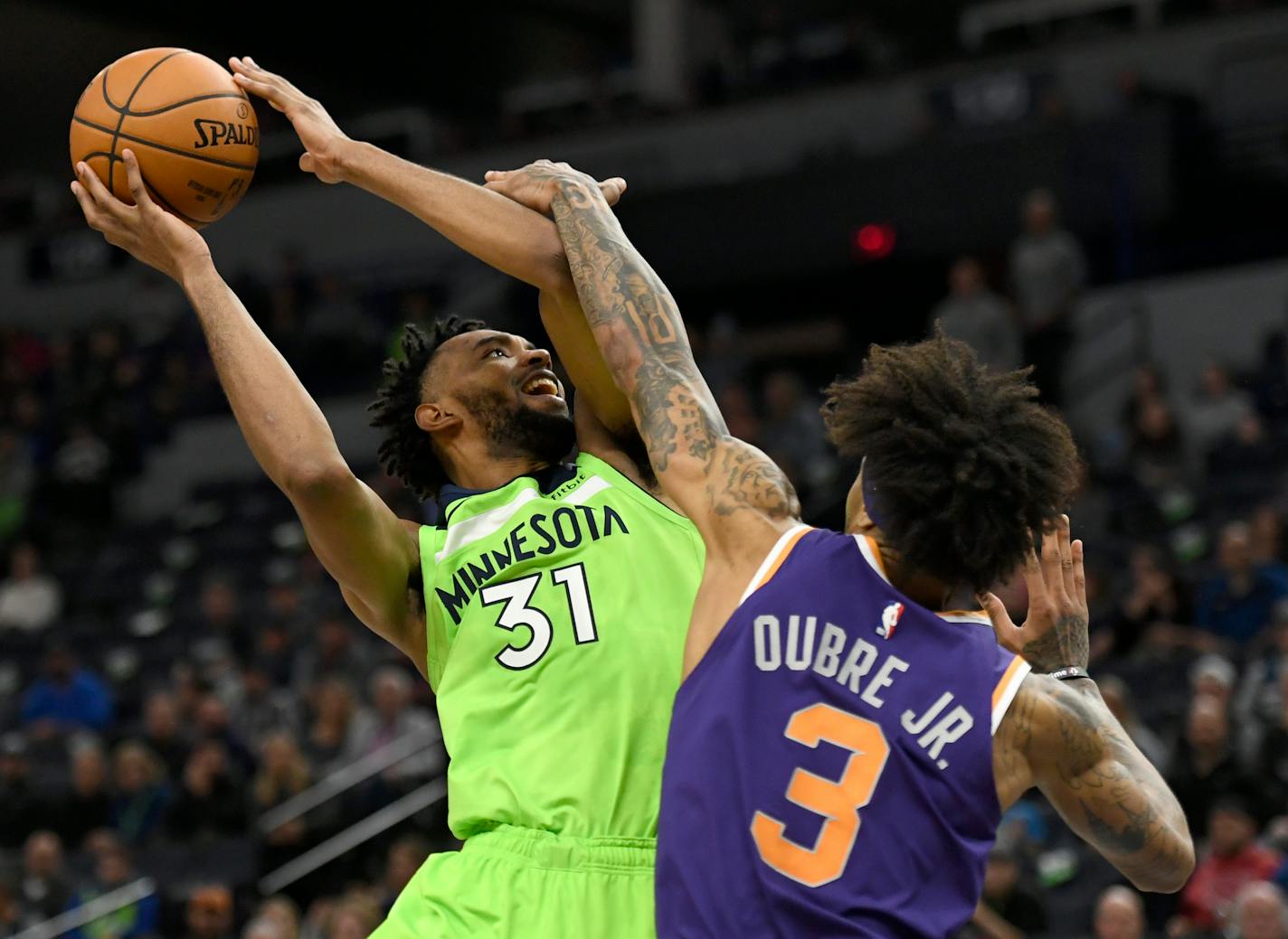 Kelly Oubre Jr. fouls the Timberwolves' Keita Bates-Diop