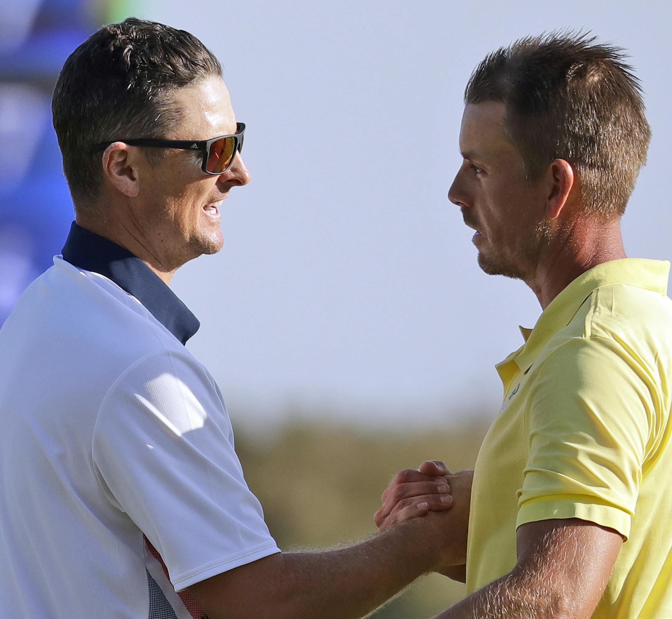 Justin Rose of Great Britain, left, and Henrik Stenson of Sweden, shake hands after Rose won gold and Stenson won silver during the final round of the men's golf event at the 2016 Summer Olympics in Rio de Janeiro, Brazil, Sunday, Aug. 14, 2016. (AP Photo/Chris Carlson) ORG XMIT: OGLF246