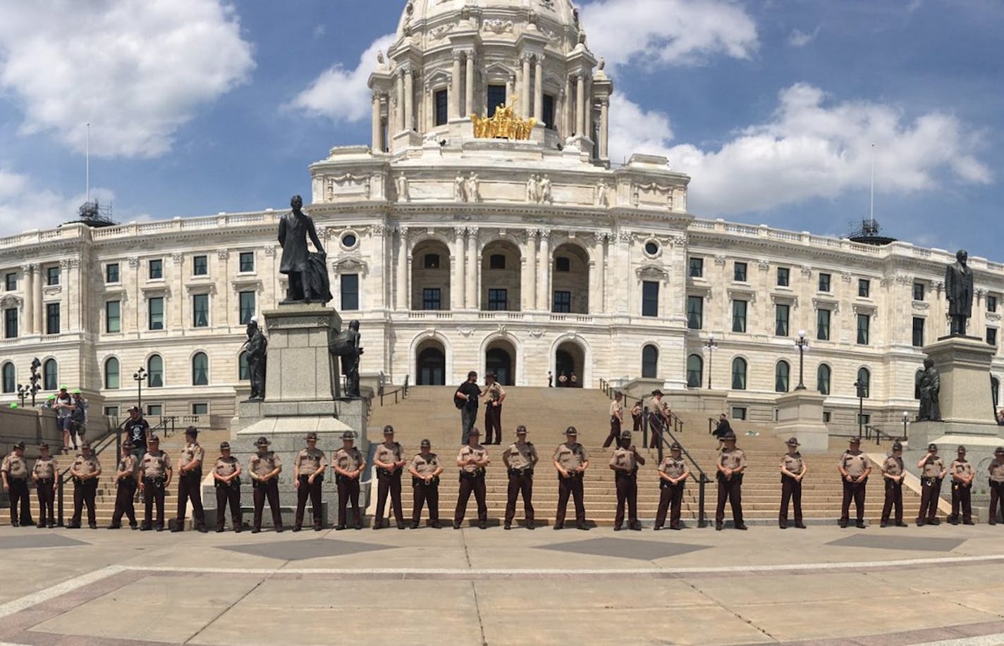 Members of the State Patrol line up in front of the Capitol steps in St. Paul after sporadic scuffles broke out Saturday, June 10, 2017, at a "March Against Sharia" and counterprotest.