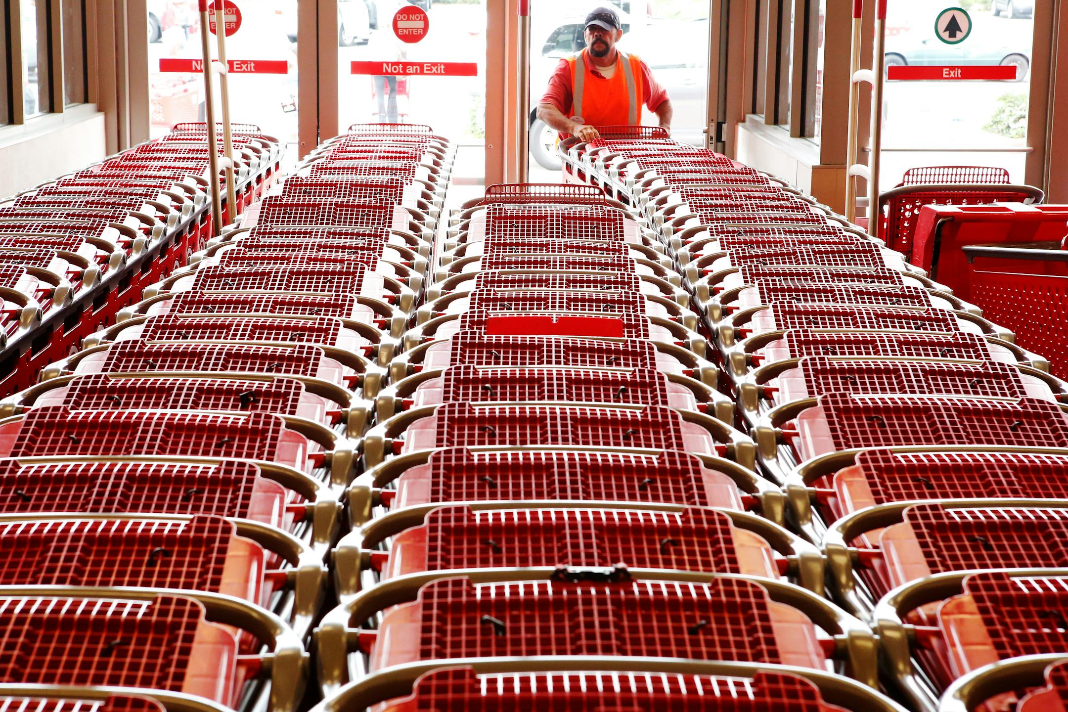 A Target employee pushes shopping carts inside the Target Corp. Store in Torrance, California, U.S., on Tuesday, August 20, 2013. Target is expected to announce quarterly earnings results on Aug. 21, 2013. Photographer: Patrick T. Fallon/Bloomberg