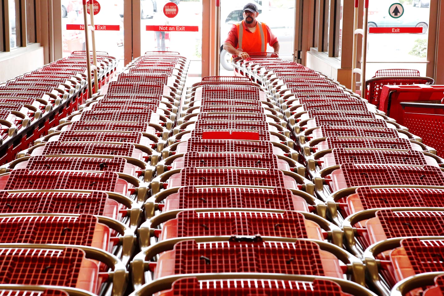 A Target employee pushes shopping carts inside the Target Corp. Store in Torrance, California, U.S., on Tuesday, August 20, 2013. Target is expected to announce quarterly earnings results on Aug. 21, 2013. Photographer: Patrick T. Fallon/Bloomberg