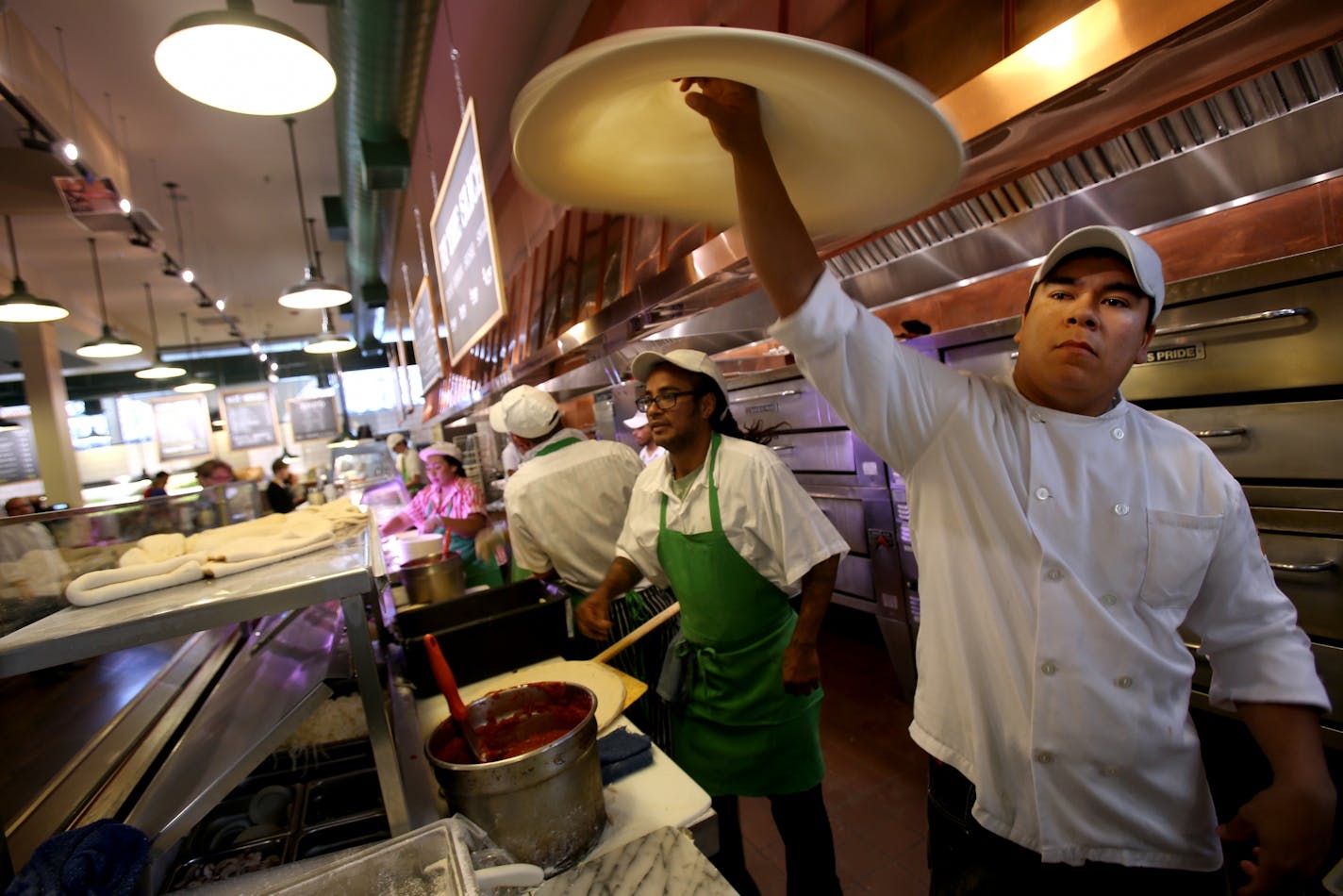 Felix Verez spins the dough for a pizza at the COUNTER at Cossettas in St. Paul, MN. September 13, 2013.