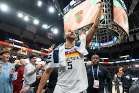 Minnesota Timberwolves forward Kyle Anderson (5) points to the crowd as he walks off the court after defeating the Memphis Grizzlies 111-100.