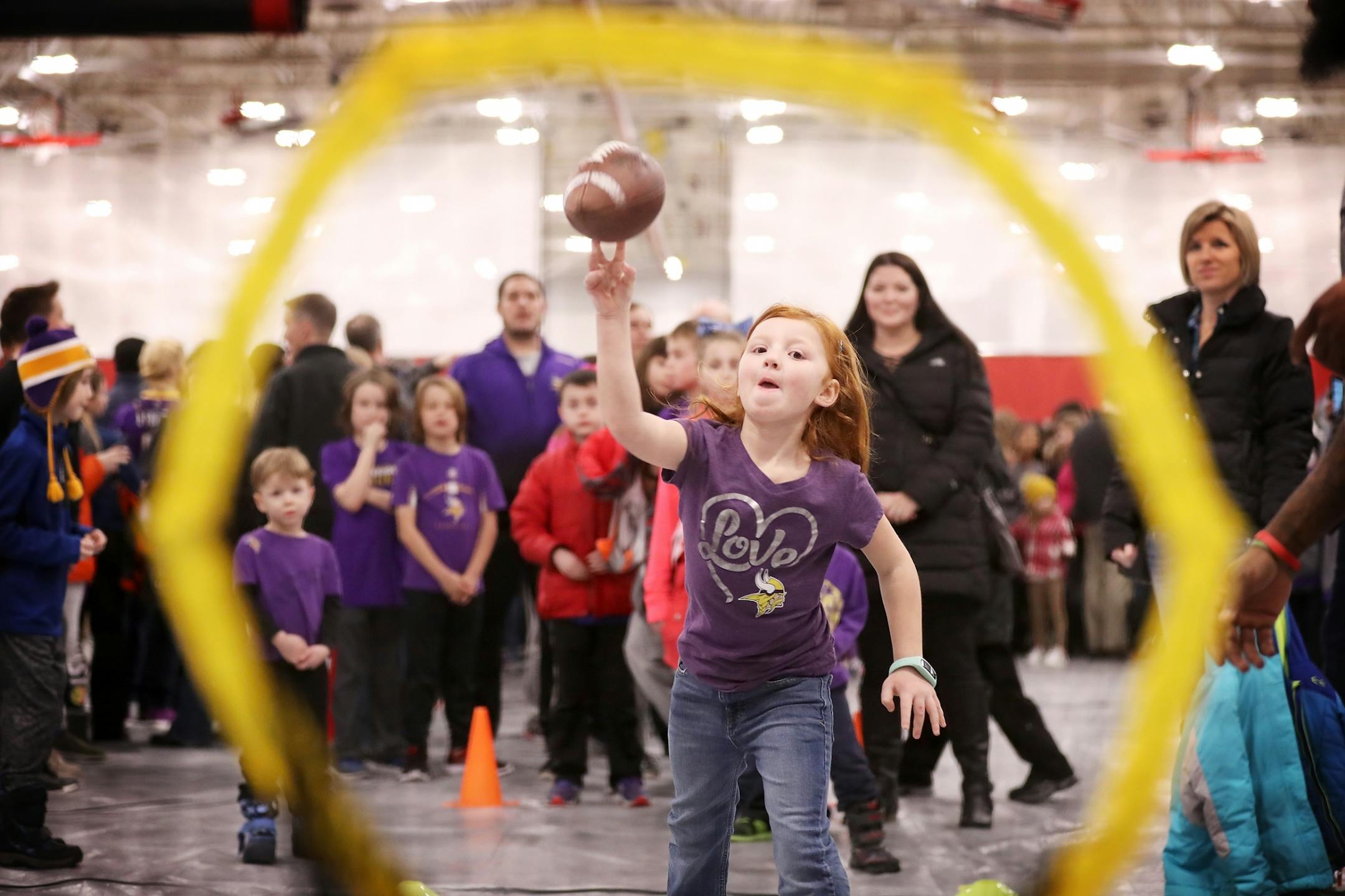 Elizabeth Stenger, 6, of Shakopee makes a perfect throw during NFL Family Football Fest .