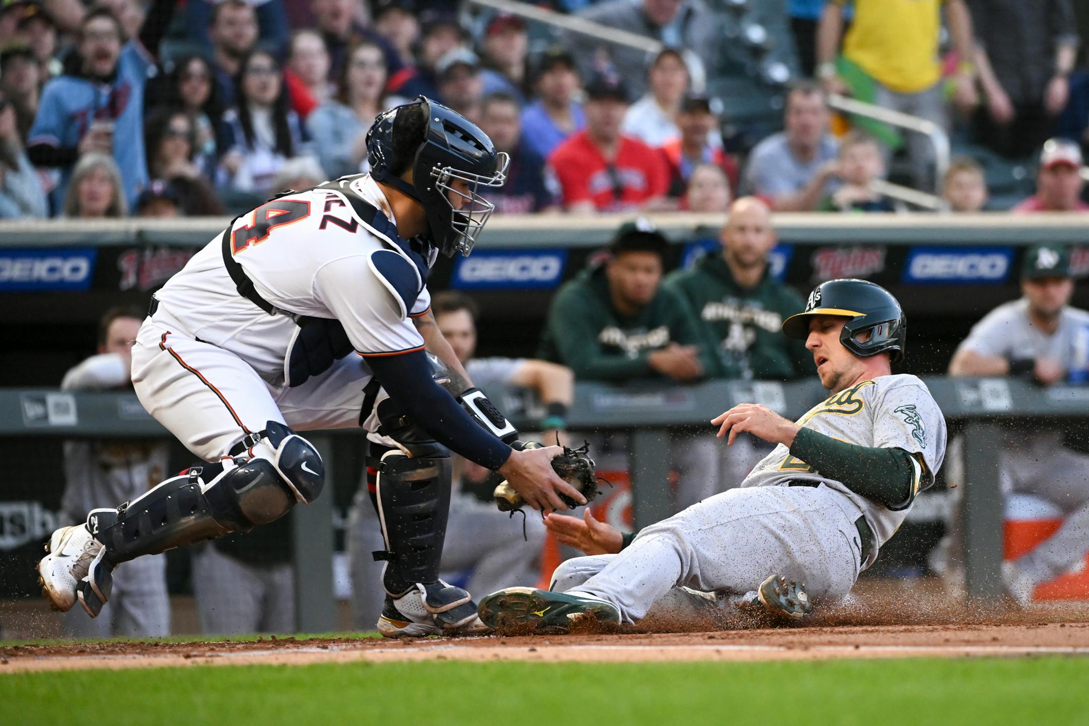Oakland Athletics right fielder Stephen Piscotty (25) is tagged out at home by Minnesota Twins catcher Gary Sanchez (24) in the top of the second inning.