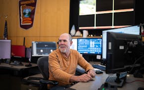State Patrol 911 dispatcher John Hutchins talks to his partner during his shift at the Minnesota Department of Transportation State Patrol dispatch ce