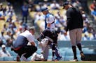 Minnesota Twins' Nick Gordon (1) is checked out for injury after he was hit by a foul ball during the fifth inning of a baseball game against the Los 