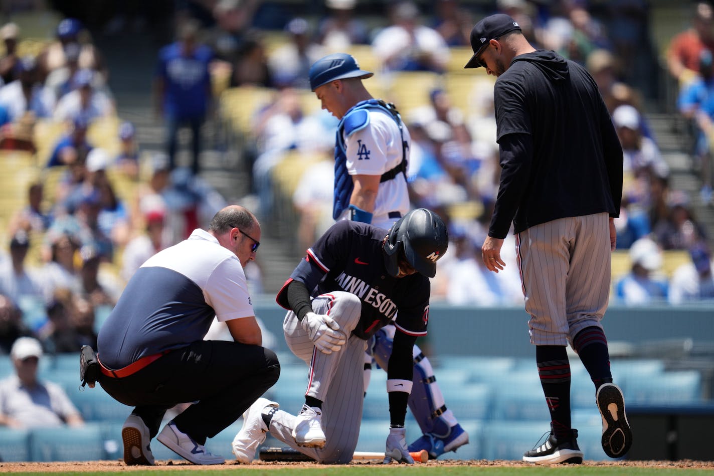 Minnesota Twins' Nick Gordon (1) is checked out for injury after he was hit by a foul ball during the fifth inning of a baseball game against the Los Angeles Dodgers in Los Angeles, Wednesday, May 17, 2023. (AP Photo/Ashley Landis)