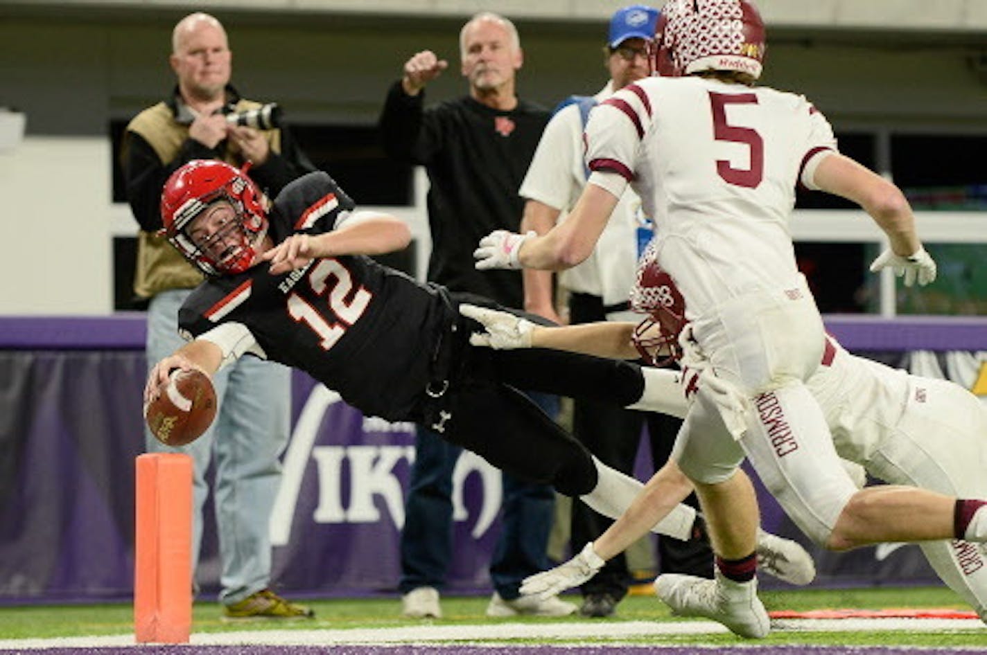 Eden Prairie quarterback Cole Kramer (12) reached for the pylon but was ruled out of bounds as he attempted to run for a touchdown in the second half. His run was good for a first down.  ] AARON LAVINSKY ' aaron.lavinsky@startribune.com