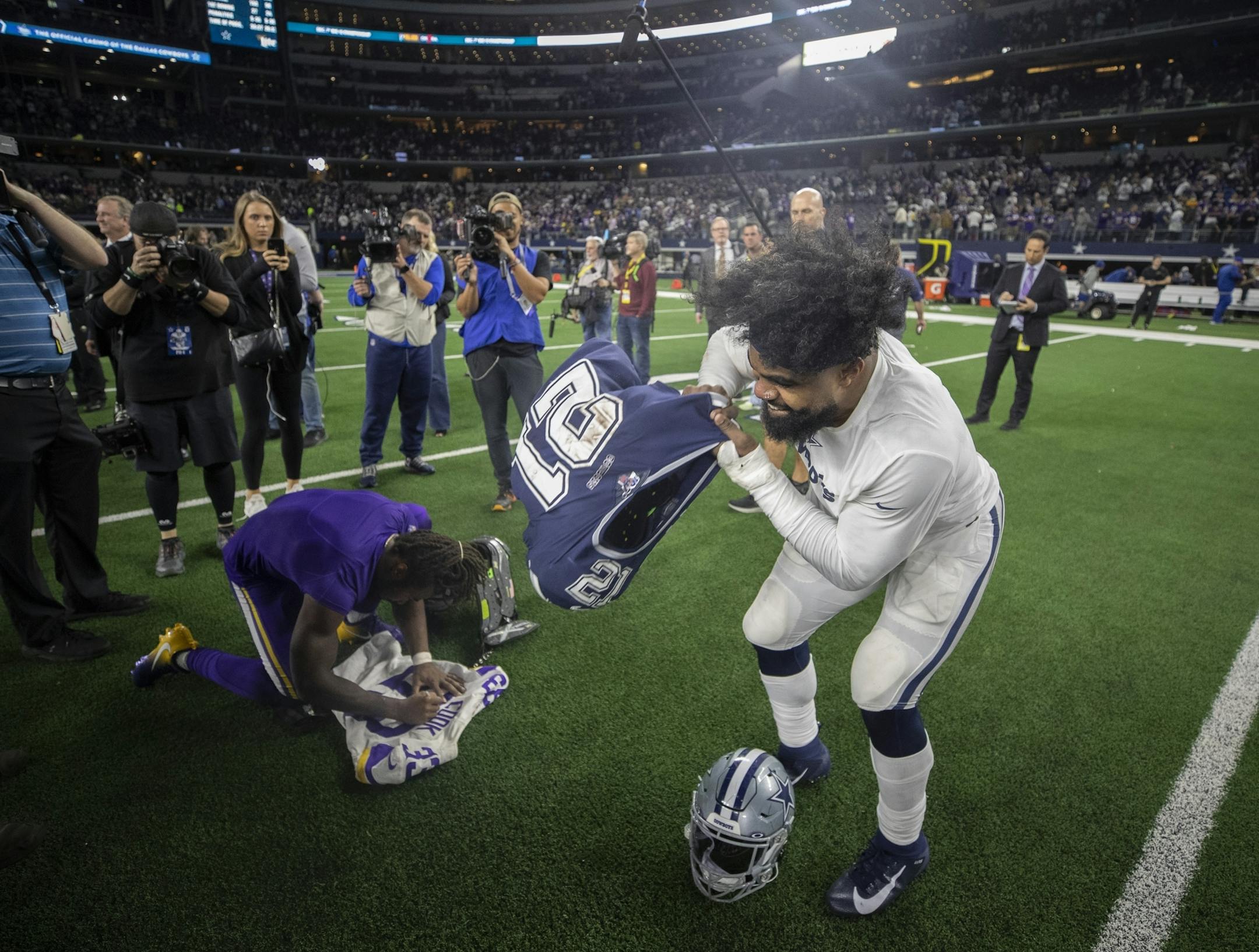 Dallas Cowboys running back Ezekiel Elliott (21) right and Minnesota Vikings running back Dalvin Cook (33) exchanged jerseys after the game at AT&T Stadium.