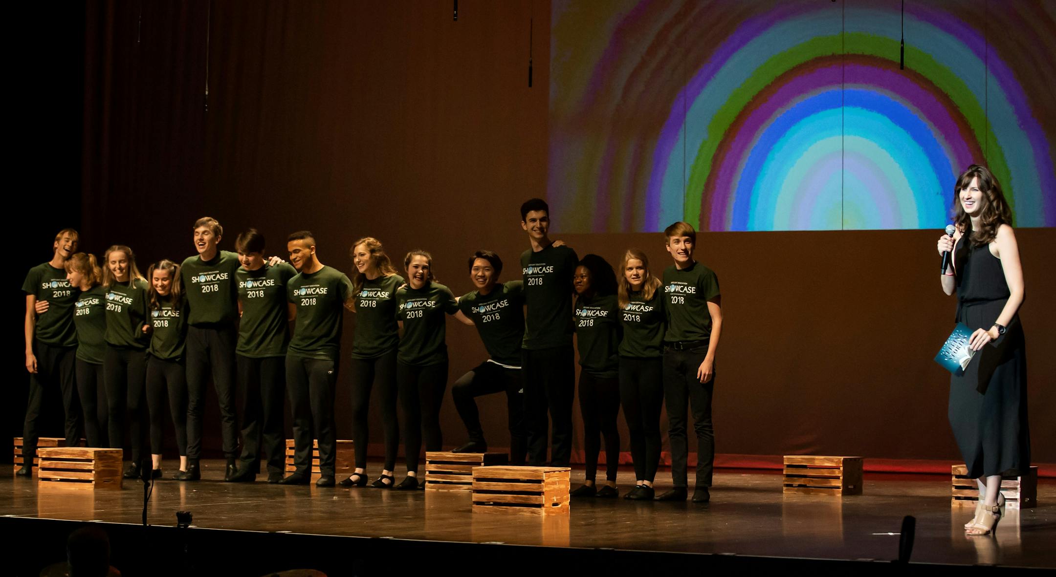 Ari Koehler Sweeney on stage with a group of young performers at the 2018 Spotlight Showcase at the State Theatre.