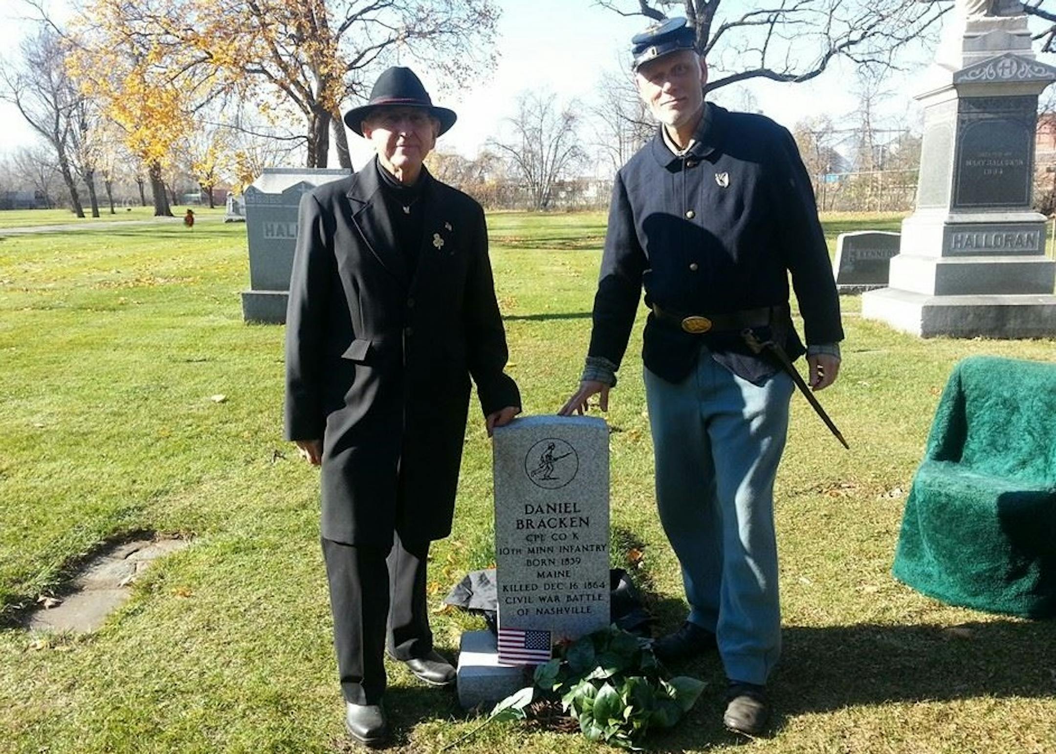 Ken Flies, left, moderated the dedication ceremony Saturday for Cpl. Daniel Bracken's new headstone at St. Anthony Cemetery in northeast Minneapolis. Jerry Anderson, right, was among the re-enactment soldiers who participated.
