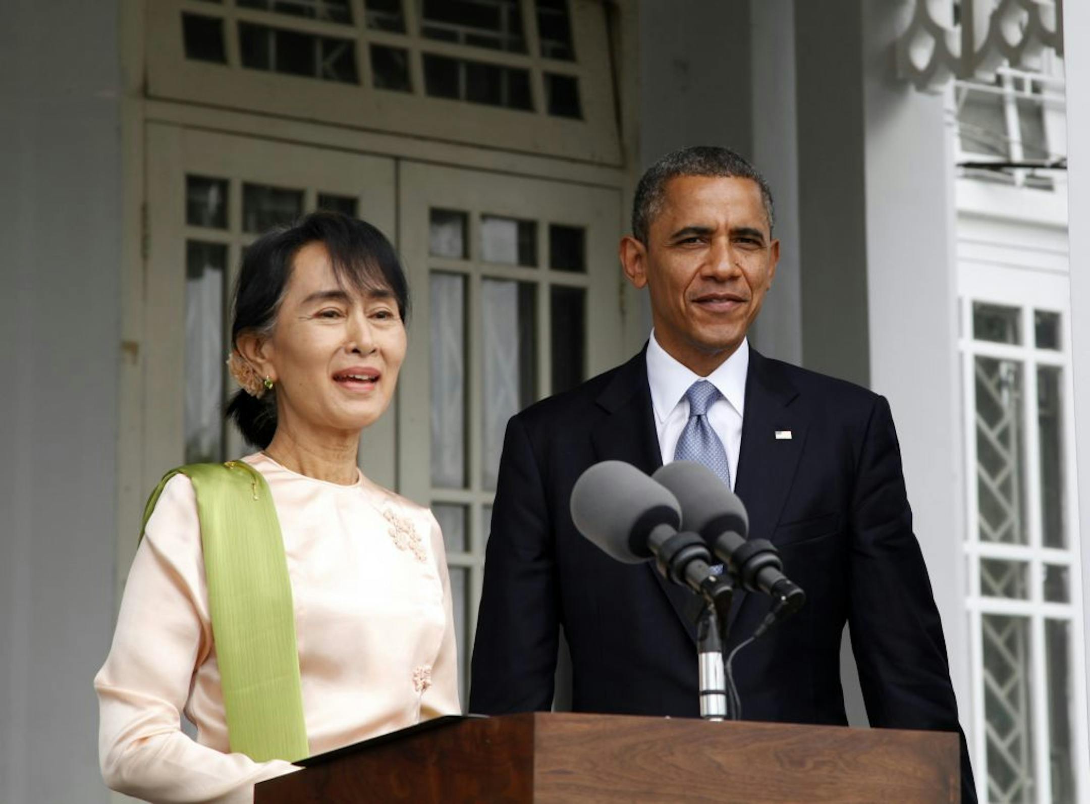 Myanmar opposition leader Aung San Suu Kyi speaks to the media next to U.S. President Barack Obama at her residence in Yangon, Myanmar, Monday, Nov. 19, 2012. Obama touched down Monday morning, becoming the first U.S. president to visit the Asian nation also known as Burma.