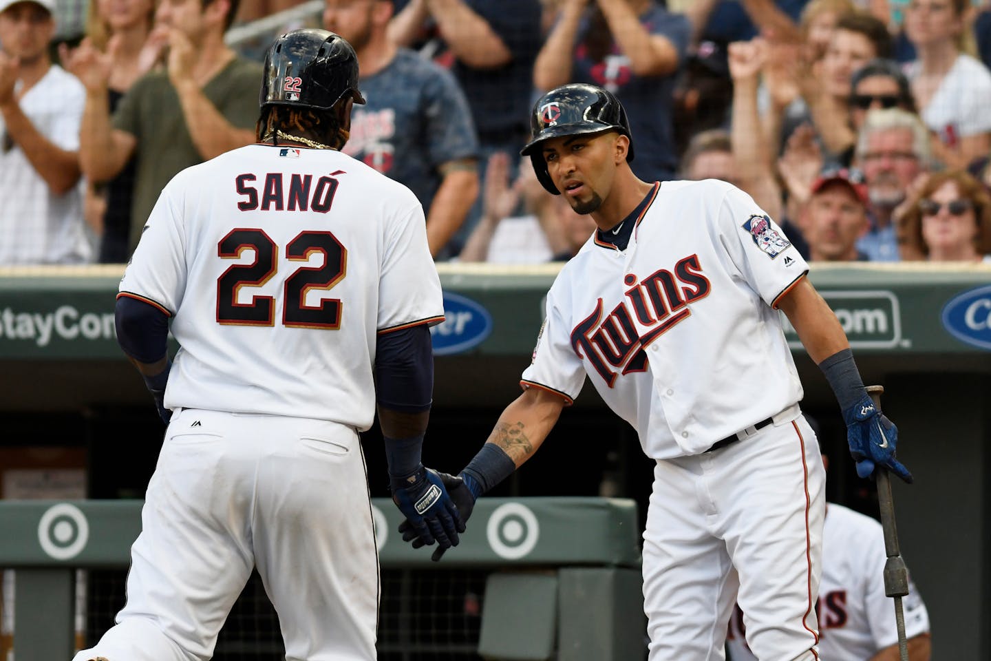 Minnesota Twins' Miguel Sano (22) is congratulated by Eddie Rosario, right, after Sano scored on a double by Robbie Grossman off Detroit Tigers pitcher Jordan Zimmermann during the third inning of a baseball game Saturday, July 22, 2017, in Minneapolis. (AP Photo/Tom Olmscheid)