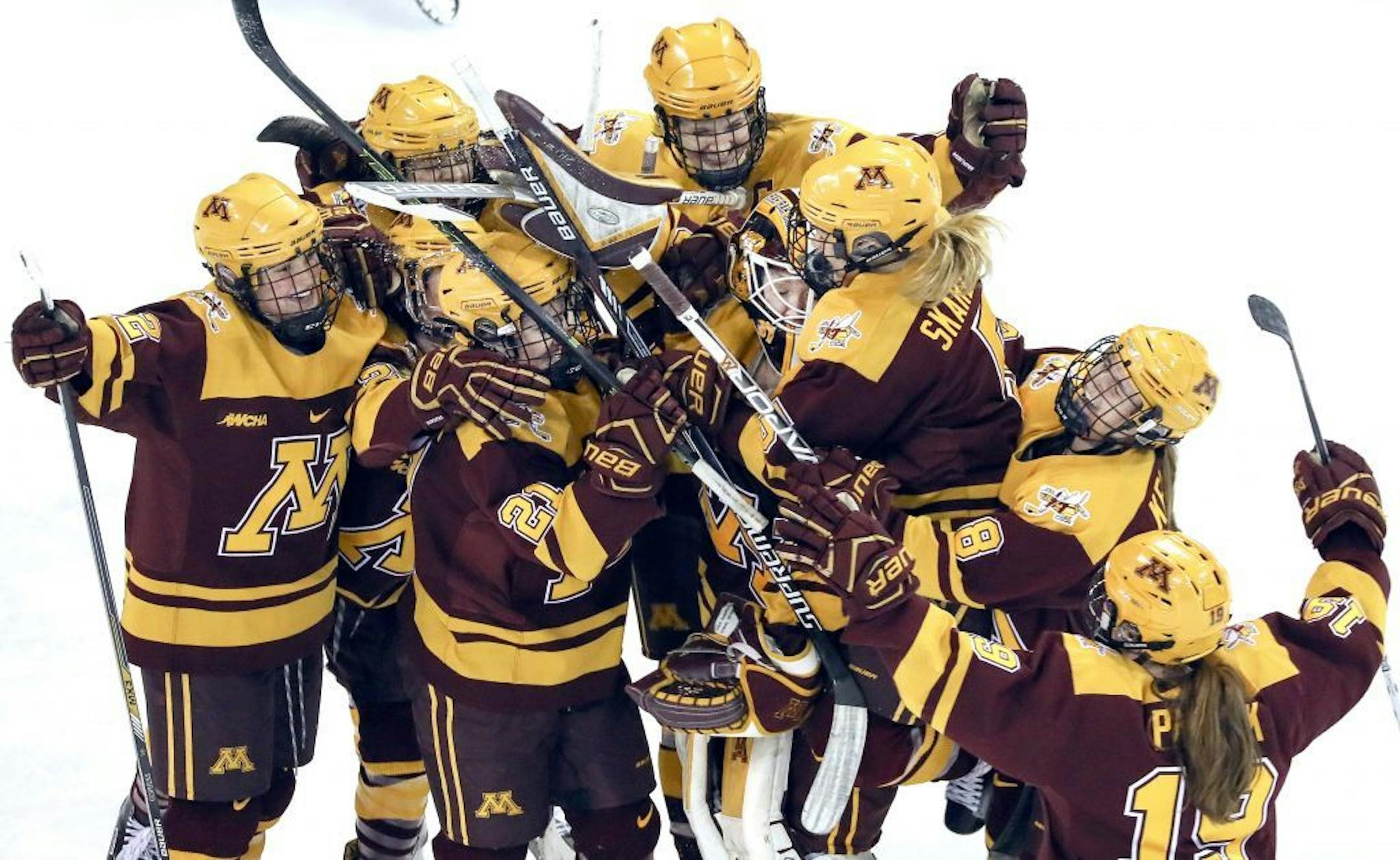 The Golden Gophers mob goaltender Sidney Peters in celebration after Saturday's 1-0 win over Minnesota Duluth in the NCAA quarterfinals.