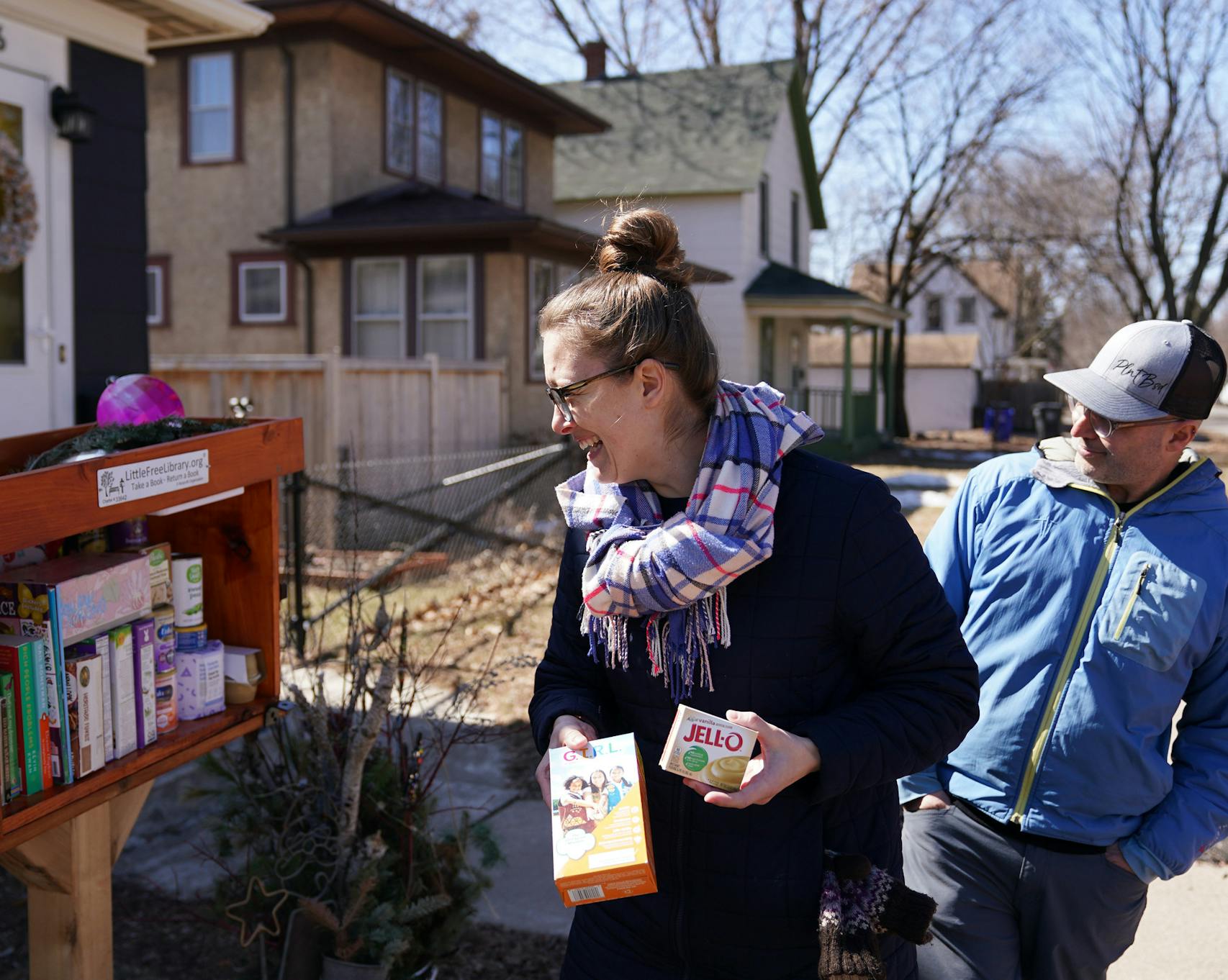 Diana Neidecker and her spouse Blake Ward, who started filling the little free library outside their home with grocery items on Monday to help those impacted by the Coronavirus. 