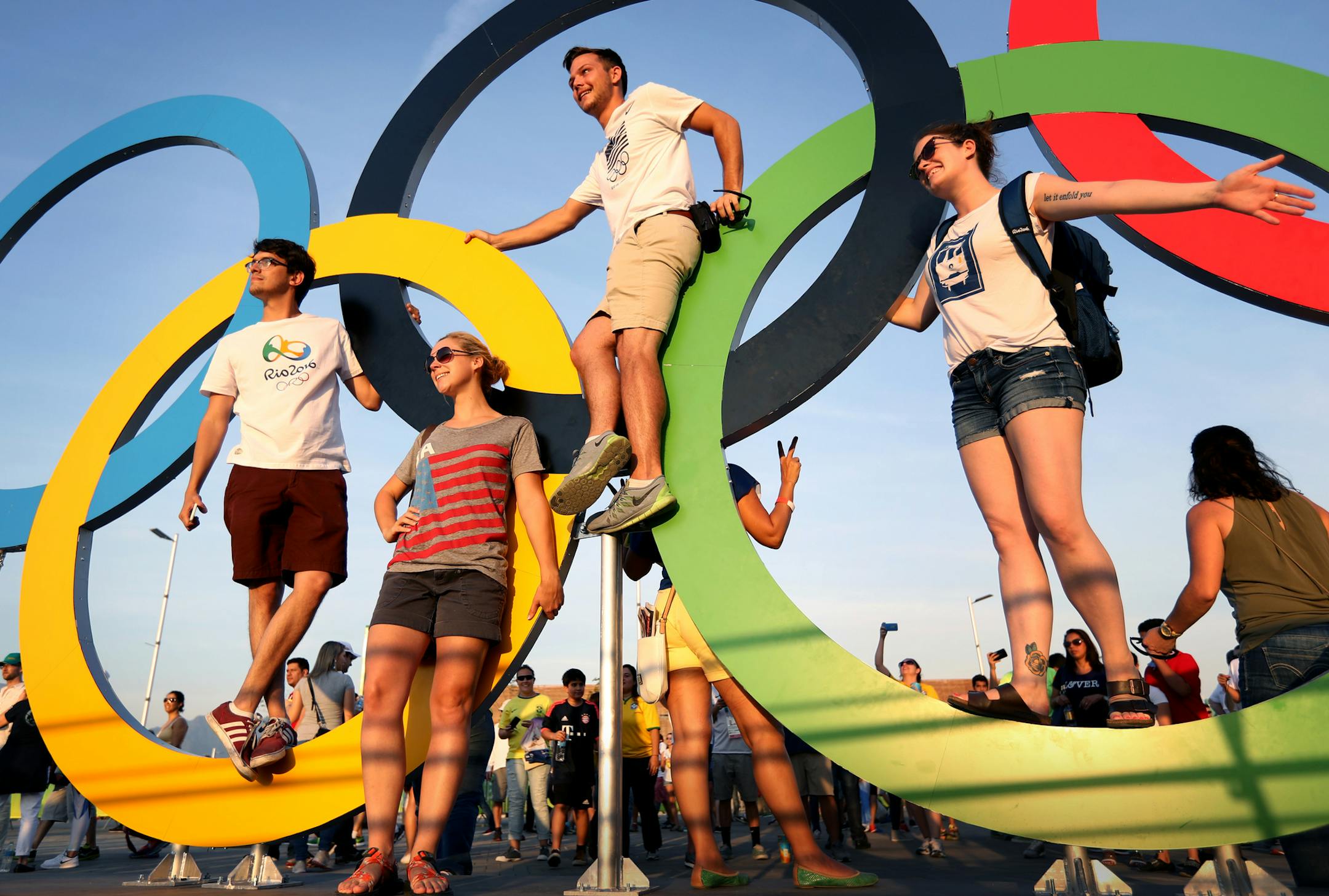 Olympic Park was hopping with Olympic fans on the first day of competition. Here, fans waited in a long line to get their pictures taken with the Olympic rings as the sun set in Rio. ] 2016 Summer Olympic Games - Rio Brazil brian.peterson@startribune.com Rio de Janeiro, Brazil - 08/06/2016
