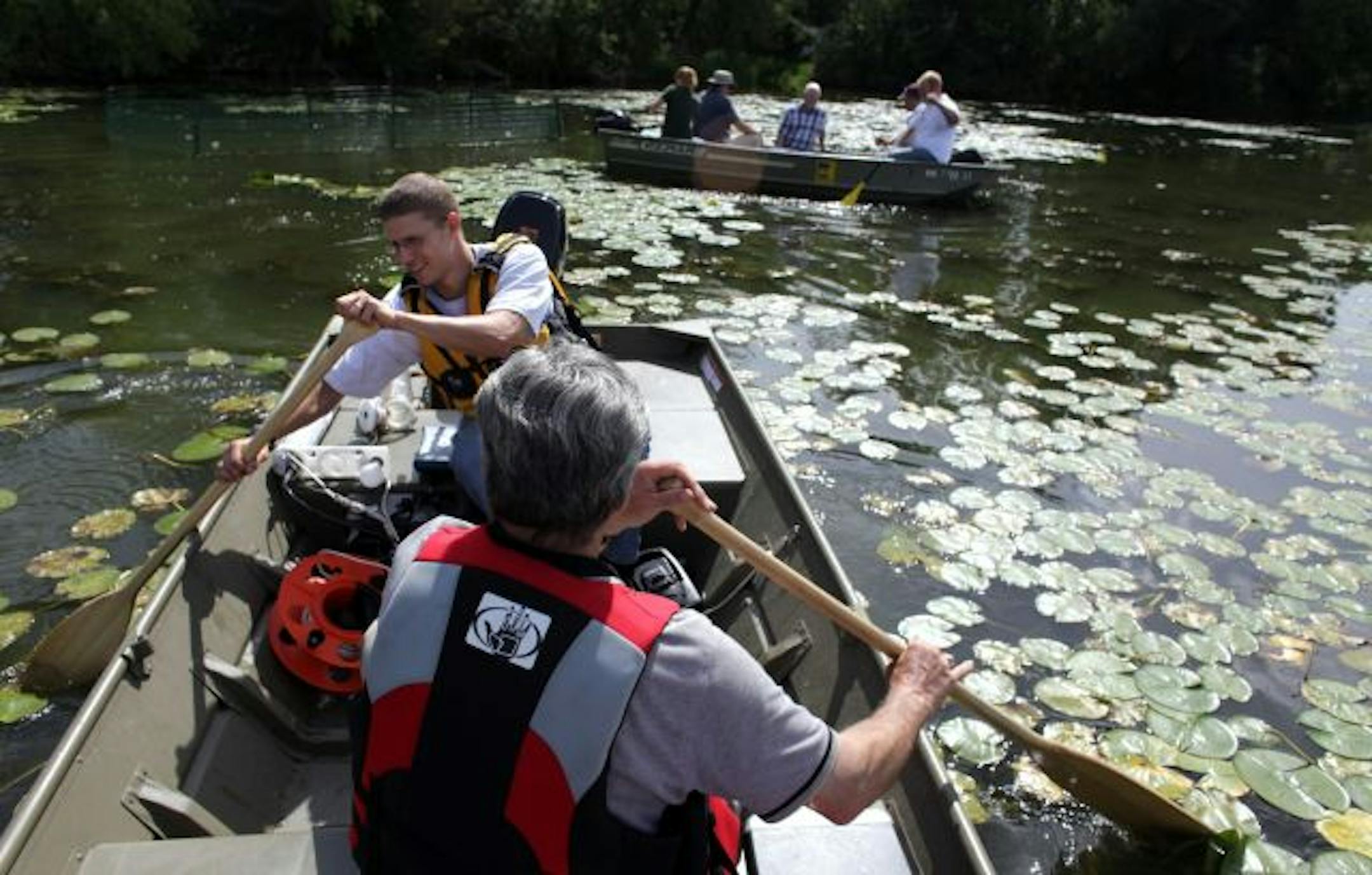 Roger Scharf, an engineering consultant, and Mike Casanova, of the Riley-Purgatory Bluff Creek Watershed District, foreground, left the southern end of Lake Susan in Chanhassen after taking a look Wednesday at controlled water vegetation they have planted. Researchers are trying to clean up area lakes.