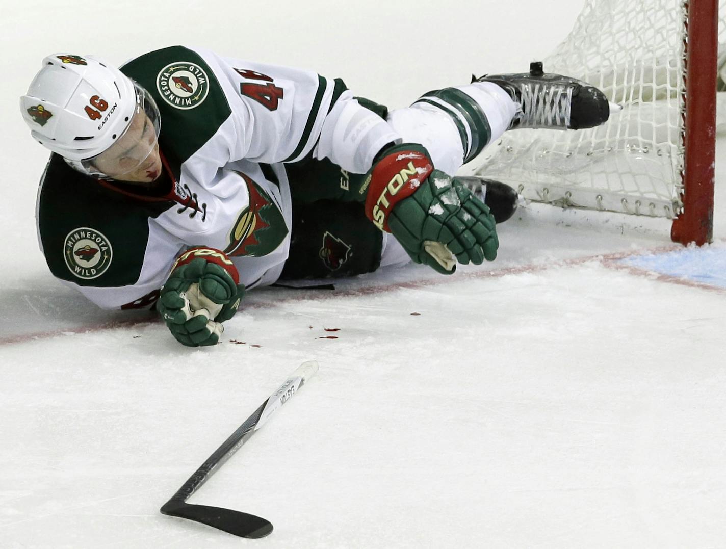 Minnesota Wild defenseman Jared Spurgeon (46) lays on the ice after he was hit with a stick during the third period of an NHL hockey game against the Dallas Stars Saturday, Jan. 9, 2016, in Dallas. The Wild won 2-1. (AP Photo/LM Otero)