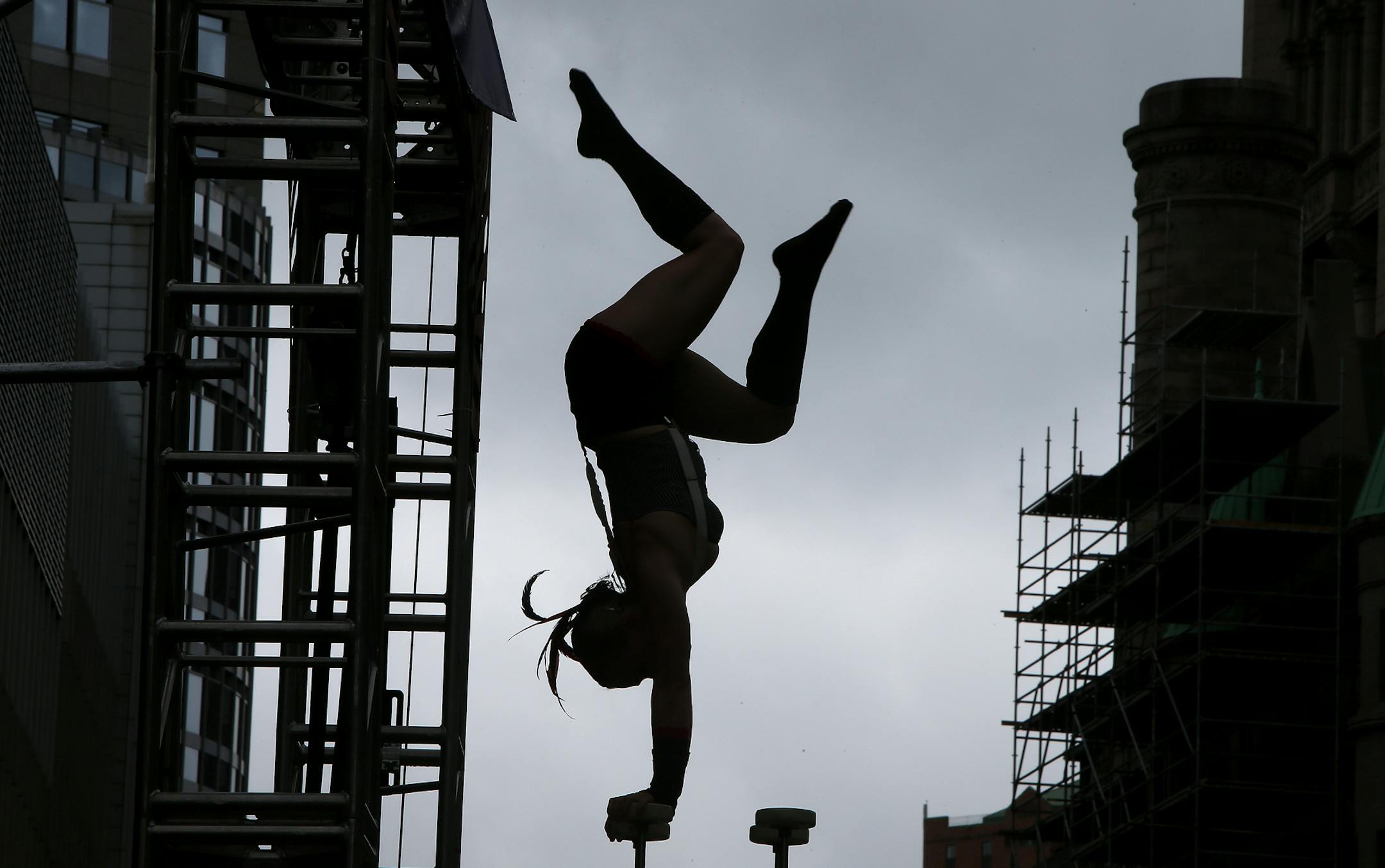 Charlotte Greenblatt, cq, performed a hand balance act with the Cirque Mechanics' Gantry Bike performance during the 14th Annual Flint Hills International Children's Festival, Thursday, May 27, 2014 in St. Paul, MN. They performed to passing students in the Landmark Plaza on Washington Street. ] (ELIZABETH FLORES/STAR TRIBUNE) ELIZABETH FLORES • eflores@startribune.com ORG XMIT: MIN1405271254440095