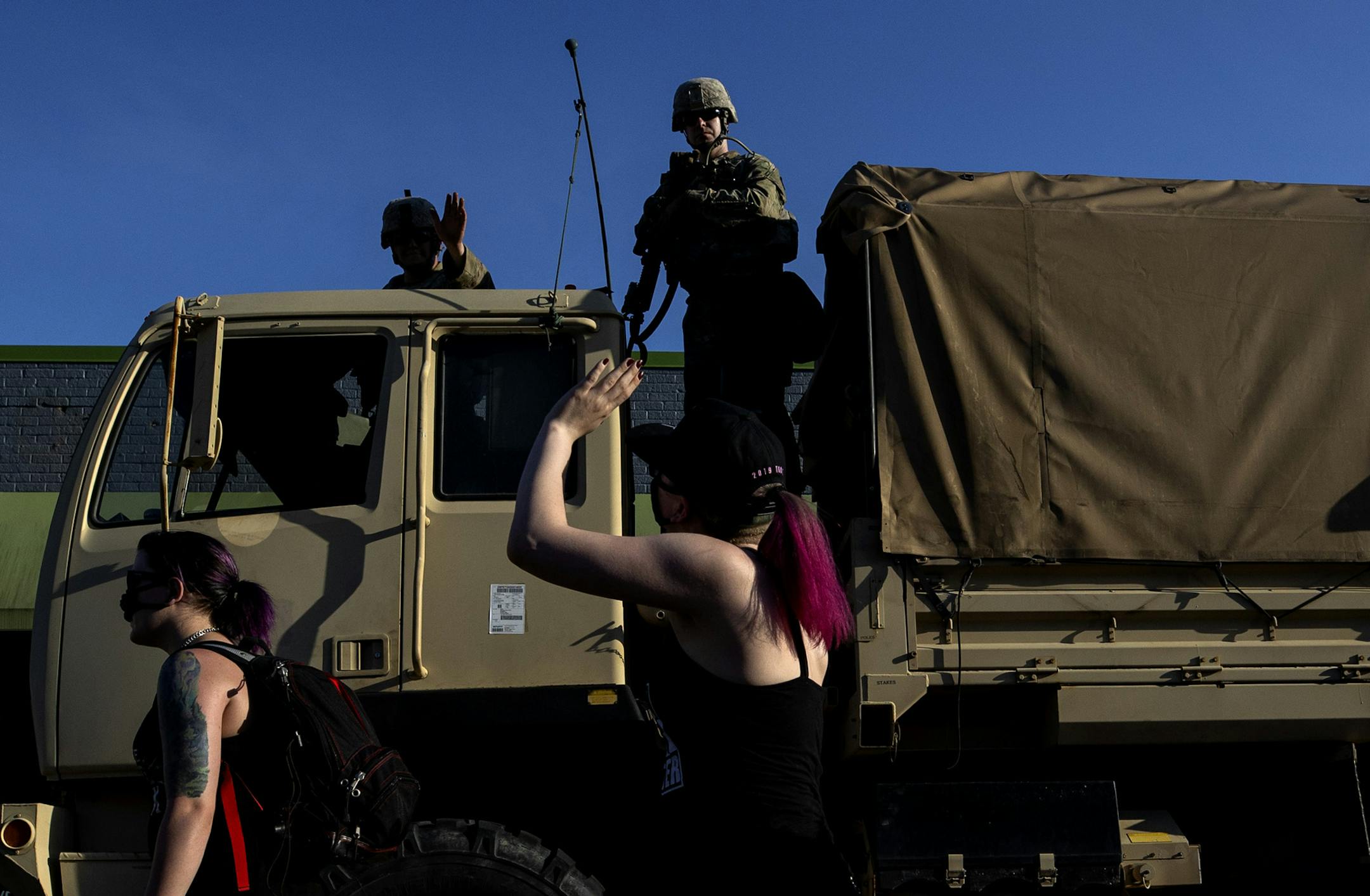 A protester and a national guard soldier exchanged waves as the protest continued on Grand Ave after leaving the Minnesota Governor's Residence in St. Paul. ] CARLOS GONZALEZ • cgonzalez@startribune.com – Minneapolis, MN – June 1, 2020, Police Protest - man died after a confrontation with Minneapolis on Monday evening. A bystander video that started circulating sometime after the incident appeared to show the man pleading with officers that he couldn't breathe - George Floyd