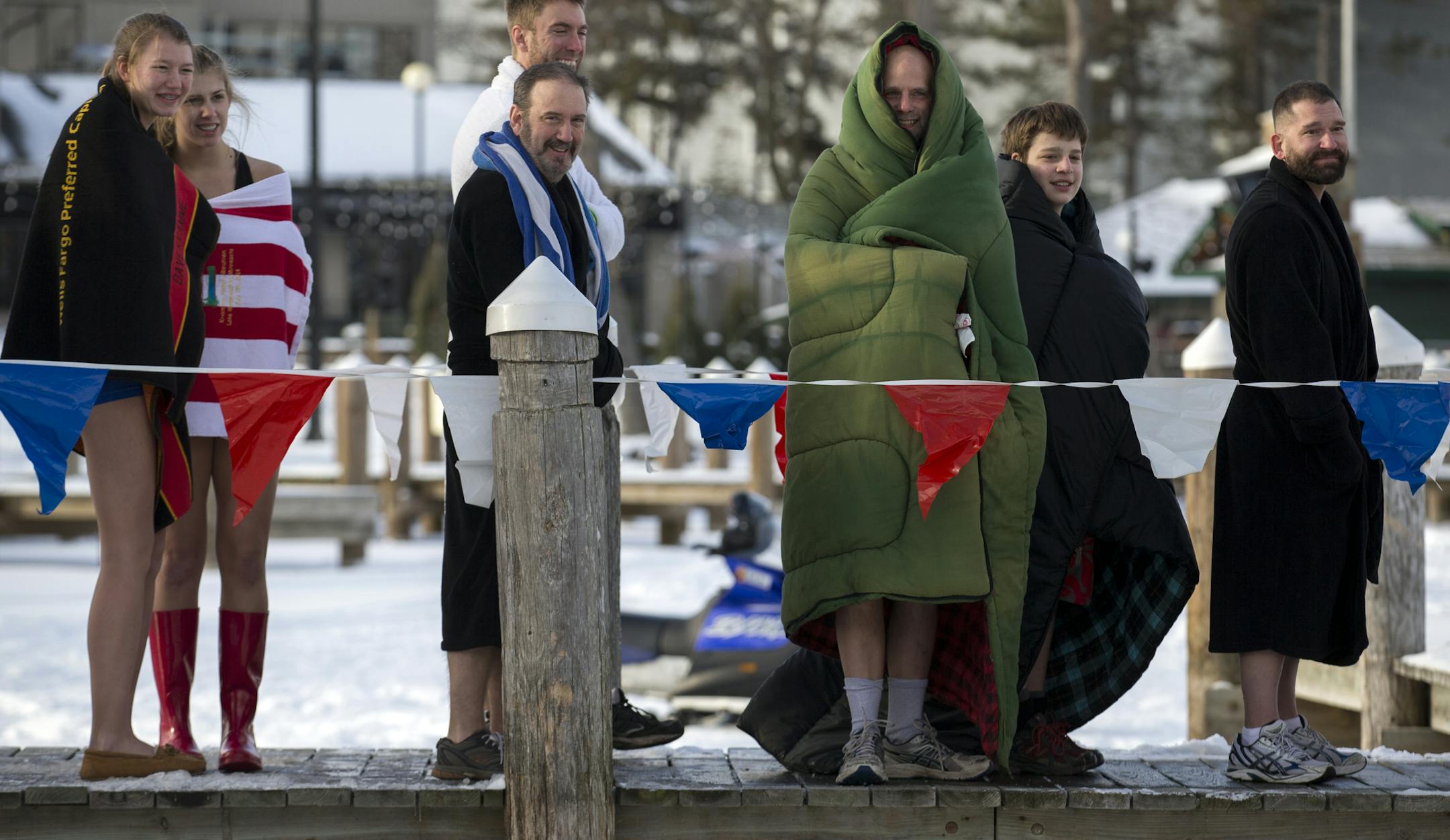 About a thousand people braved the frigid water to bring in the new year by jumping into Lake Minnetonka for the annual ALARC Ice Dive. For those waiting their turn, staying warm came in many forms. ] BRIAN PETERSON ‚Ä¢ brian.peterson@startribune.com Excelsior, MN 01/01/15