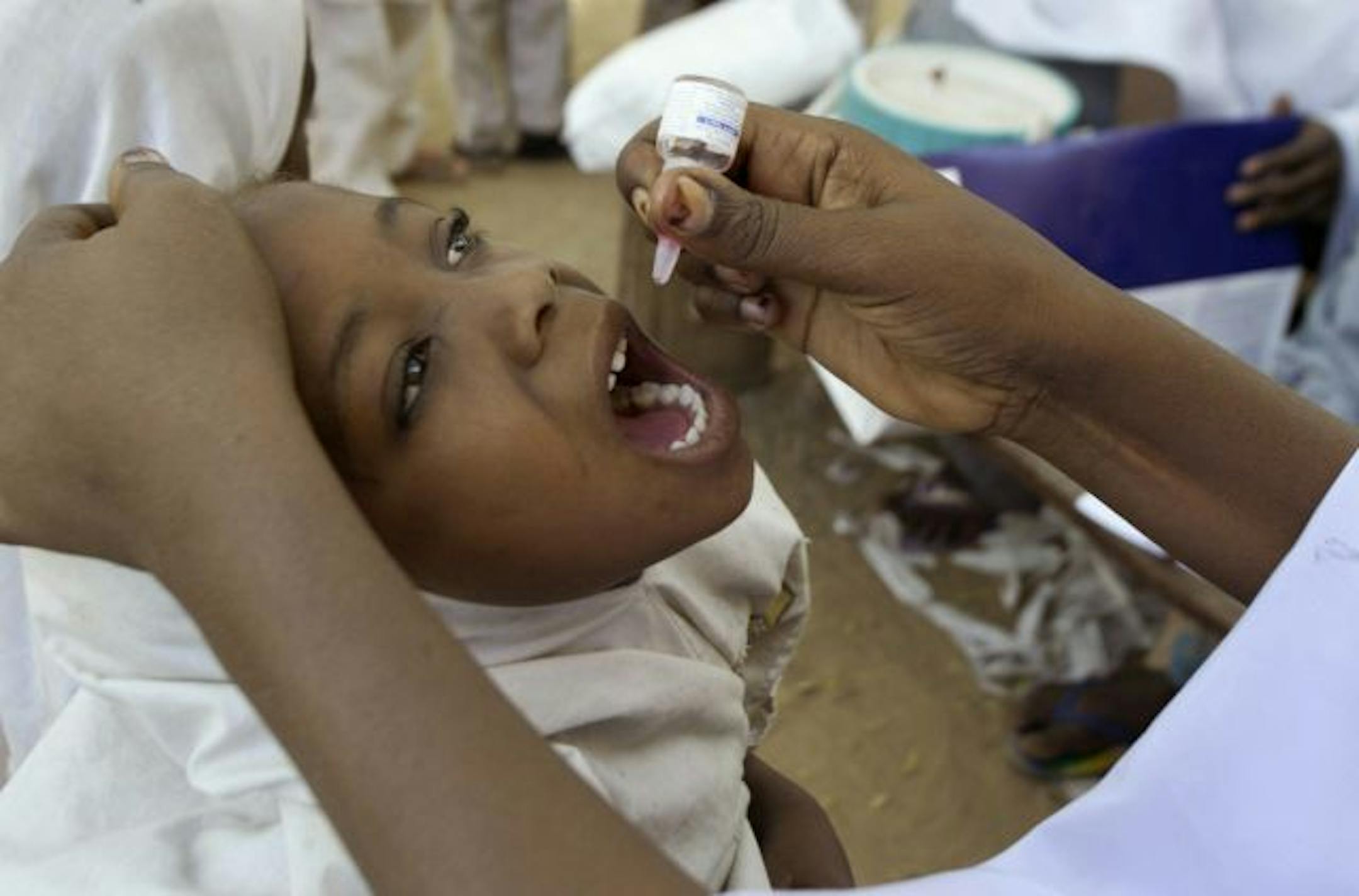 File photo: A health worker gives a child an oral polio vaccine in Nigeria.