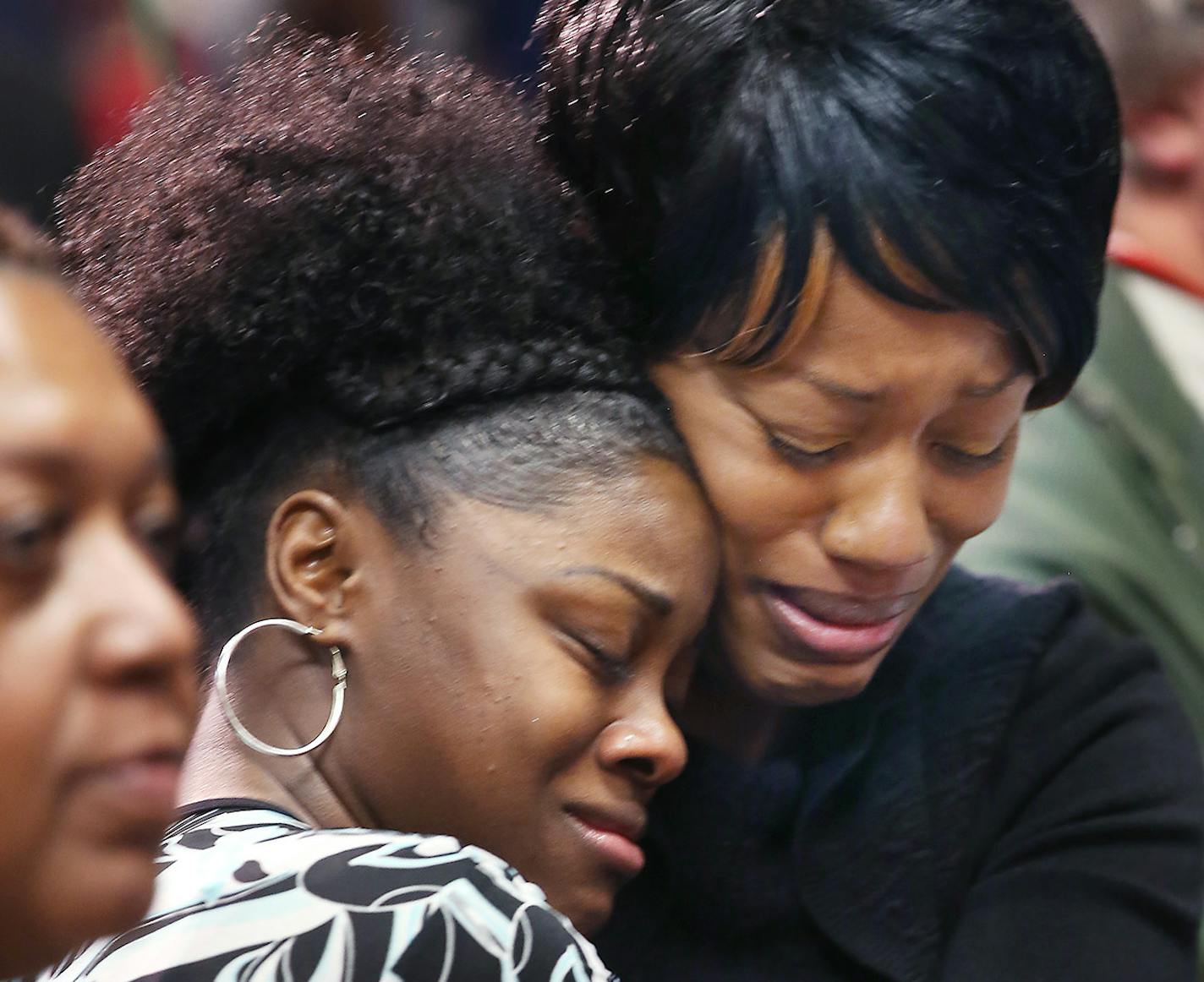 Jamar Clark's family, including his sister Javille Burns, right, hugged Tiffany Burns, his niece, during a press conference regarding Clark's death at the Minneapolis Urban League, Wednesday, November 18, 2015 in Minneapolis, MN. ] (ELIZABETH FLORES/STAR TRIBUNE) ELIZABETH FLORES &#x2022; eflores@startribune.com