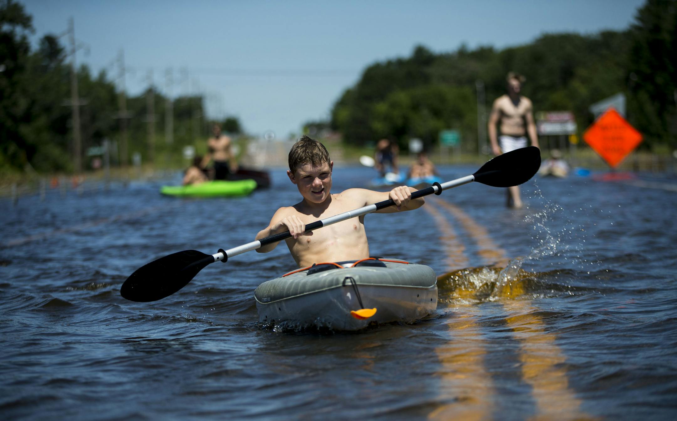 Parker Mitchell and his friends decided to take the rare opportunity of the highway being flooded and kayak right on it. ] ALEX KORMANN • alex.kormann@startribune.com Mora, MN is a small rural community in central Minnesota. On Thursday 8-10 inches of rain fell in a matter of hours causing flash flooding throughout the area. But as the water drained from all over the town it caused Lake Mora and Snake River to rise rapidly and flood local streets, highways and county roads. On Monday N. W