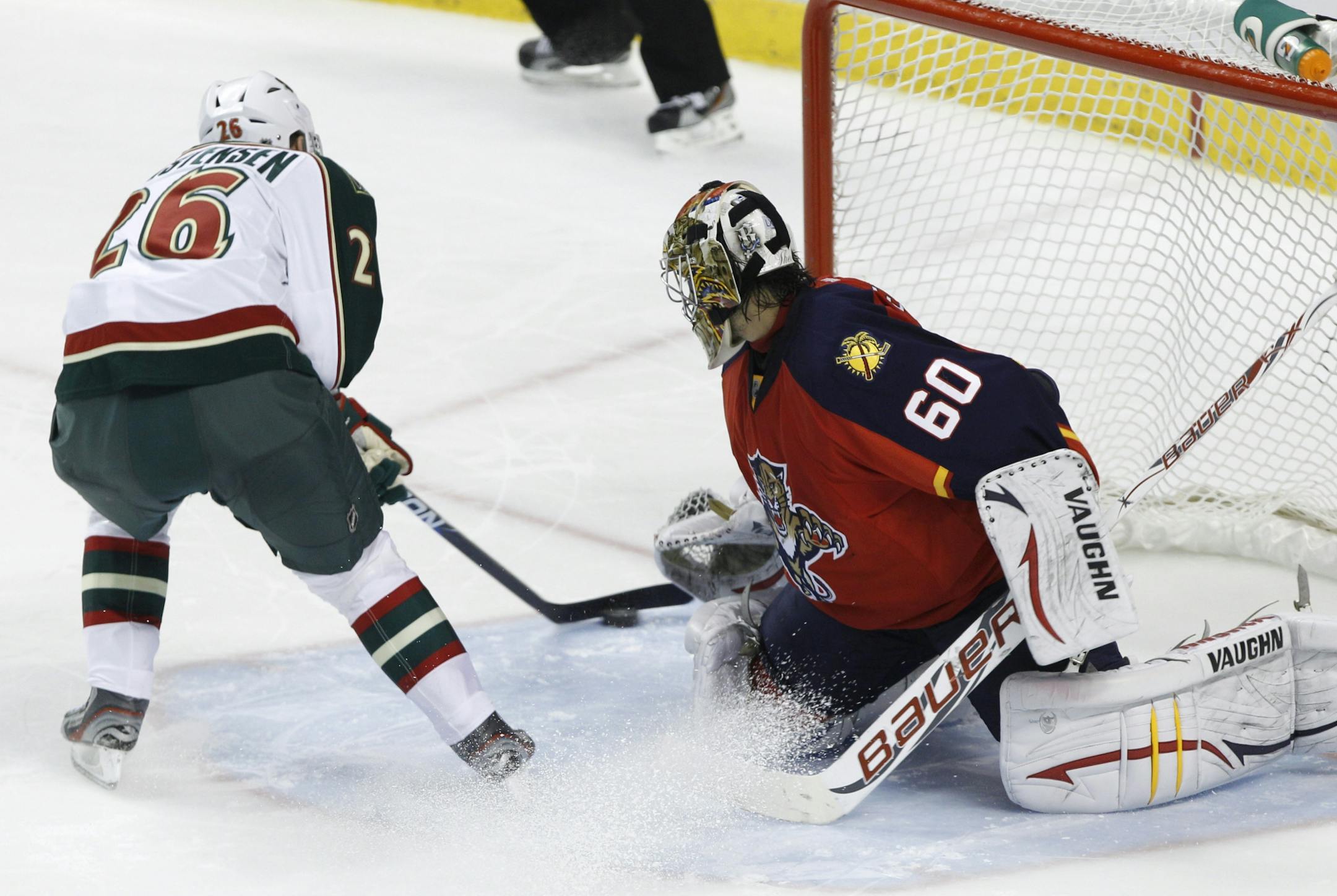 Minnesota's Erik Christensen (26) scores against Florida goalie Jose Theodore.