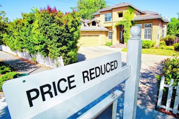 A home for sale is posted at a reduced price in Palo Alto, Calif., Thursday, June 24, 2010. Mortgage rates fell this week to the lowest level on recor