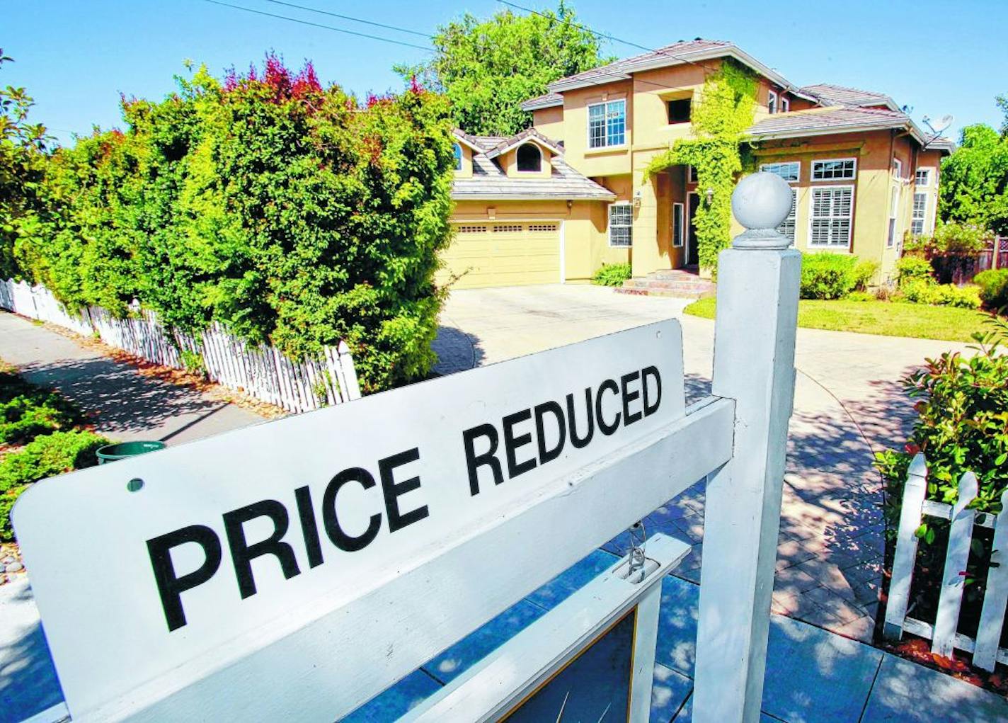 A home for sale is posted at a reduced price in Palo Alto, Calif., Thursday, June 24, 2010. Mortgage rates fell this week to the lowest level on record, giving consumers added incentive to lock in low payments for home purchases and refinanced loans.