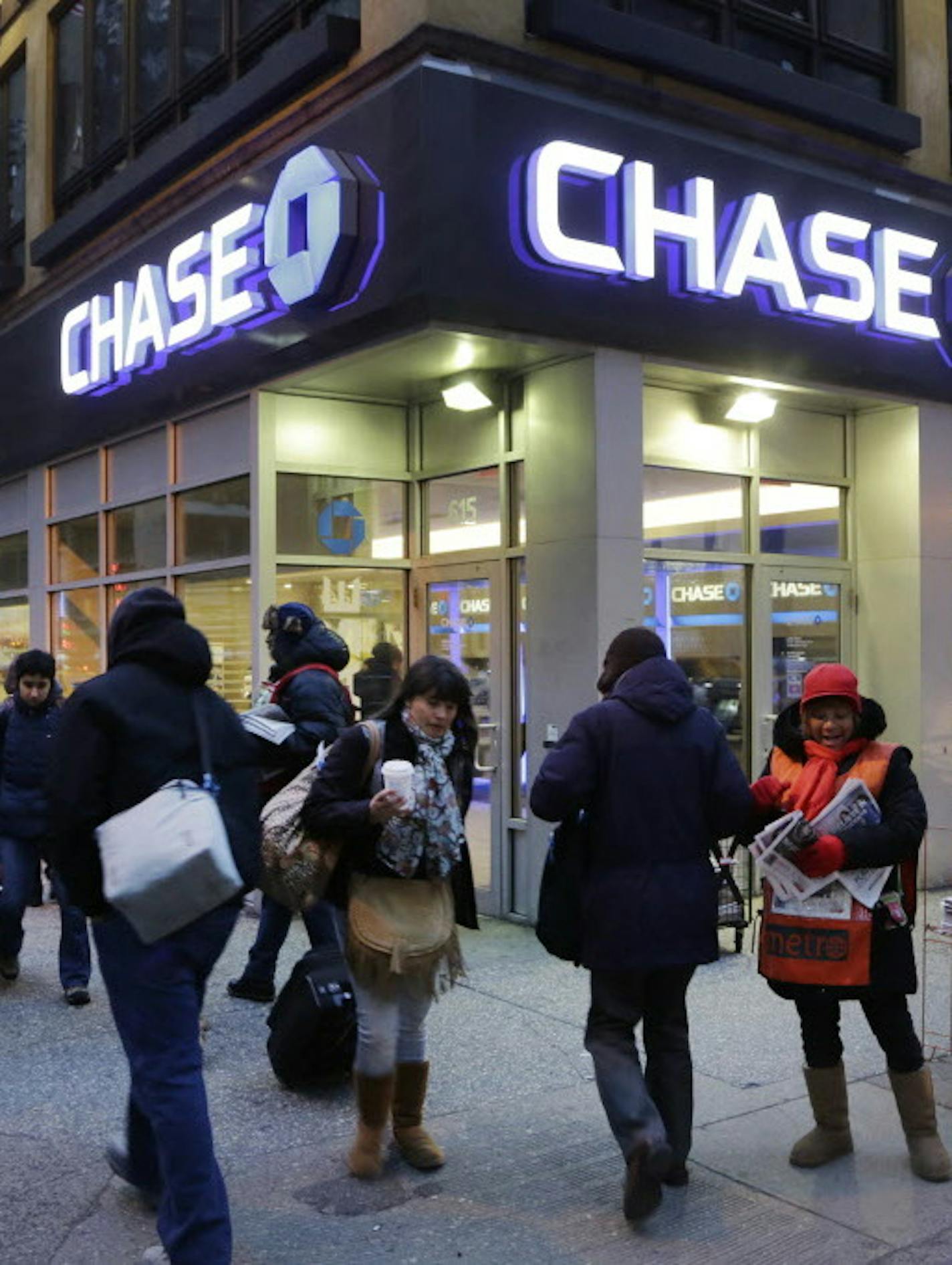 FILE - In this Jan. 14, 2015, file photo, people walk past a branch of Chase Bank, in New York. JPMorgan Chase & Co. (JPM) on Wednesday, April 13, 2016, reported first-quarter earnings. (AP Photo/Mark Lennihan, File)