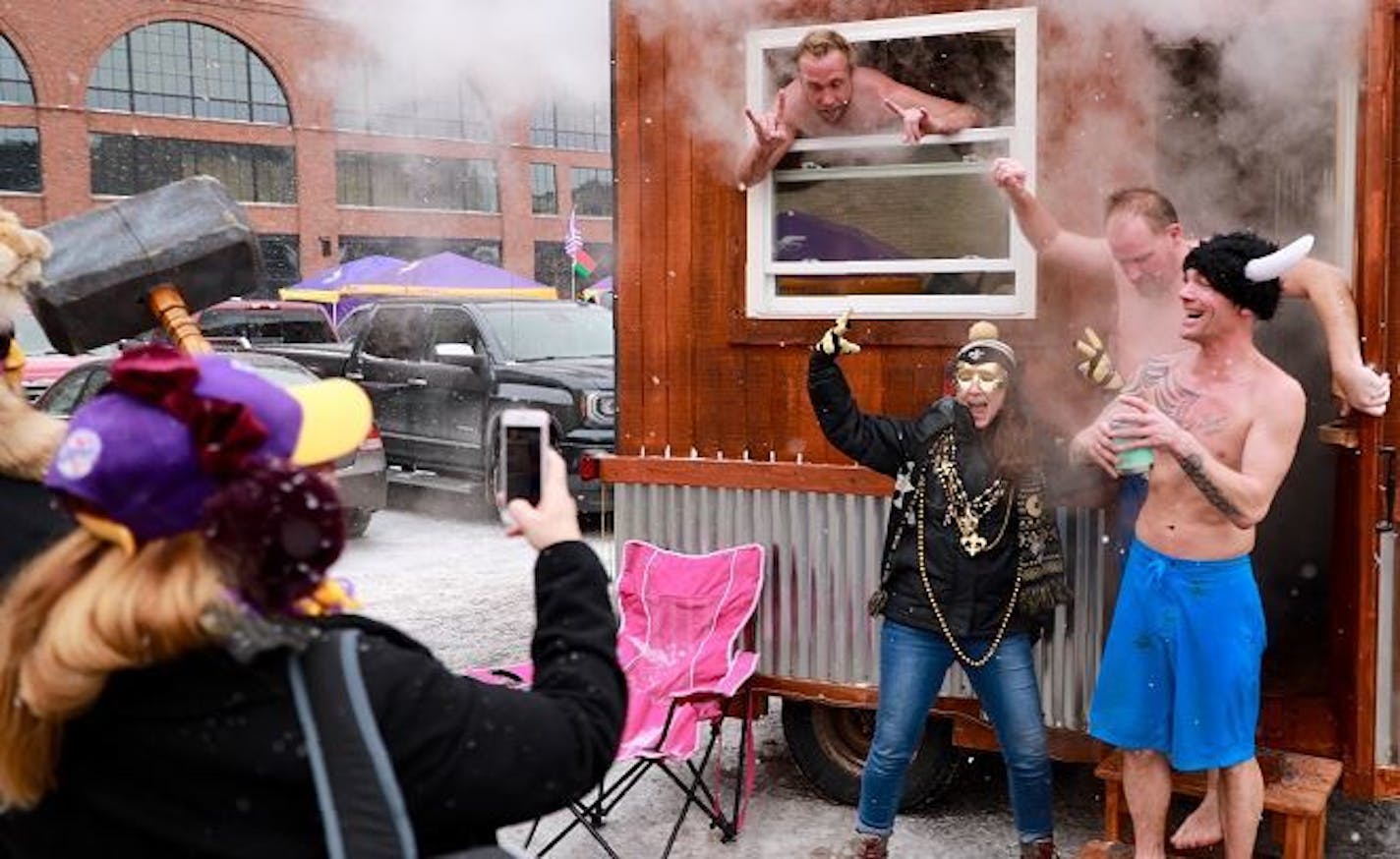 Karl Forsman, of Minnetonka (in window), hosted free sauna rounds for folks needing a little heat outside U.S. Bank Stadium on Sunday.