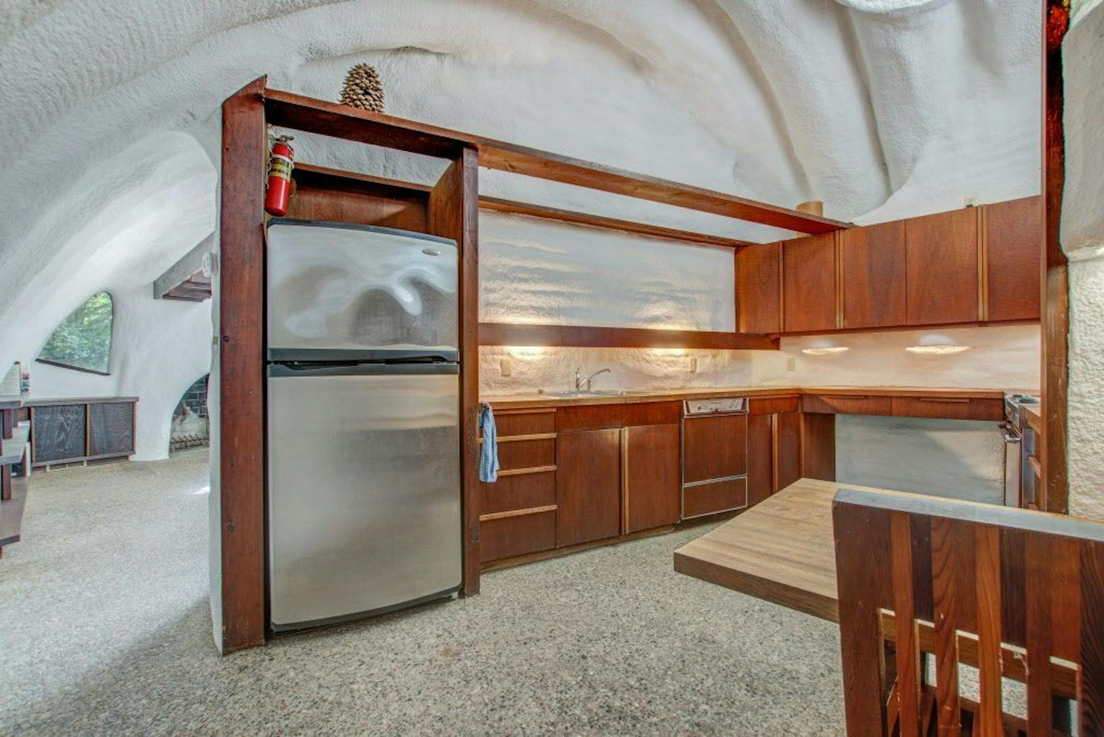The kitchen is retro '70s mahogany cabinets and butcher block counters.