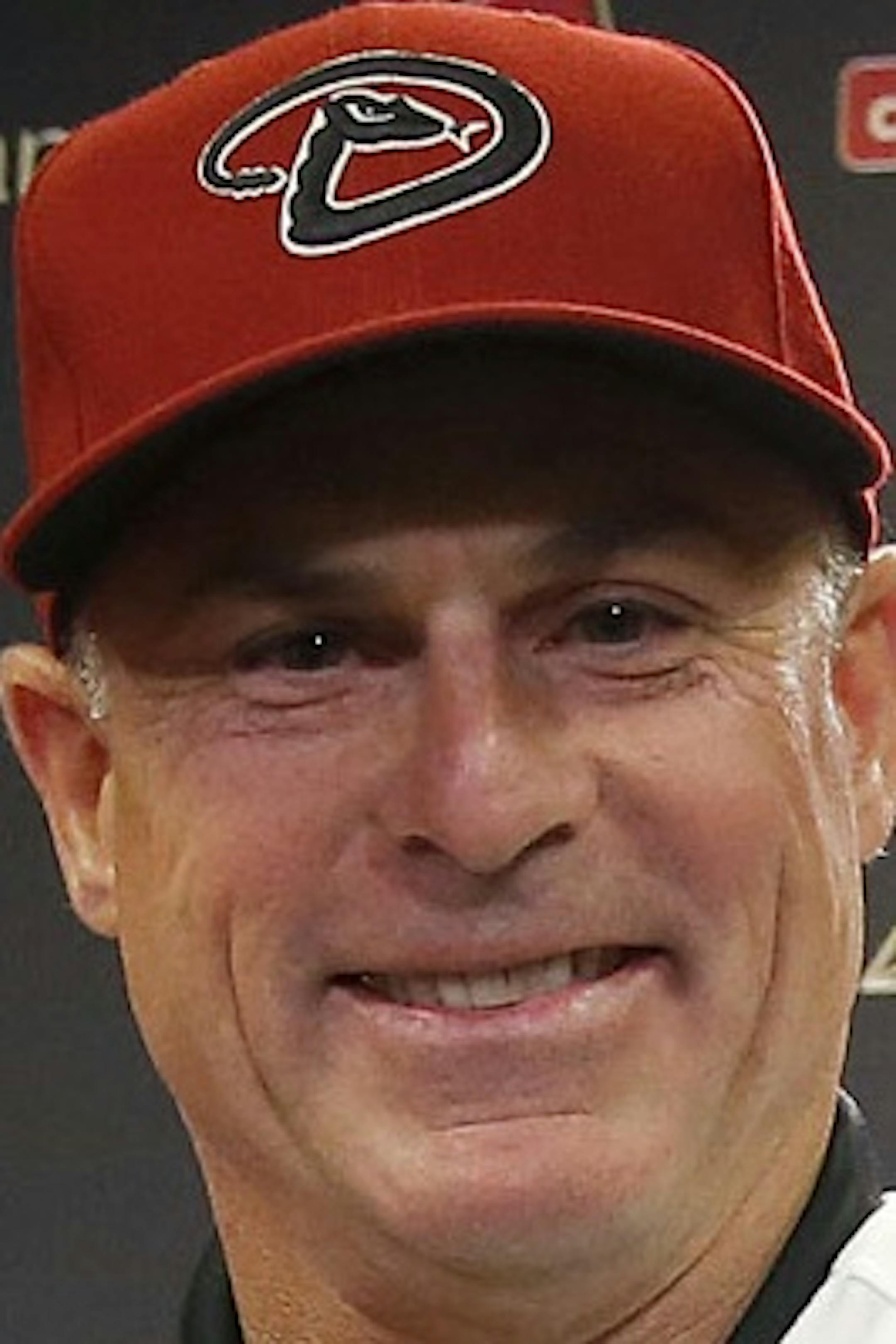 New Arizona Diamondbacks baseball team manager Chip Hale, middle, smiles as he is flanked by general manager Dave Stewart, left, and chief baseball officer Tony LaRussa during a news conference Monday, Oct. 13, 2014, in Phoenix. The former Diamondbacks third base coach was hired Monday to replace fired Kirk Gibson as the Diamondbacks manager. The 49-year-old managed in Arizona's minor league system for six seasons and was with the Diamondbacks from 2007-09 in the first of eight consecutive seaso