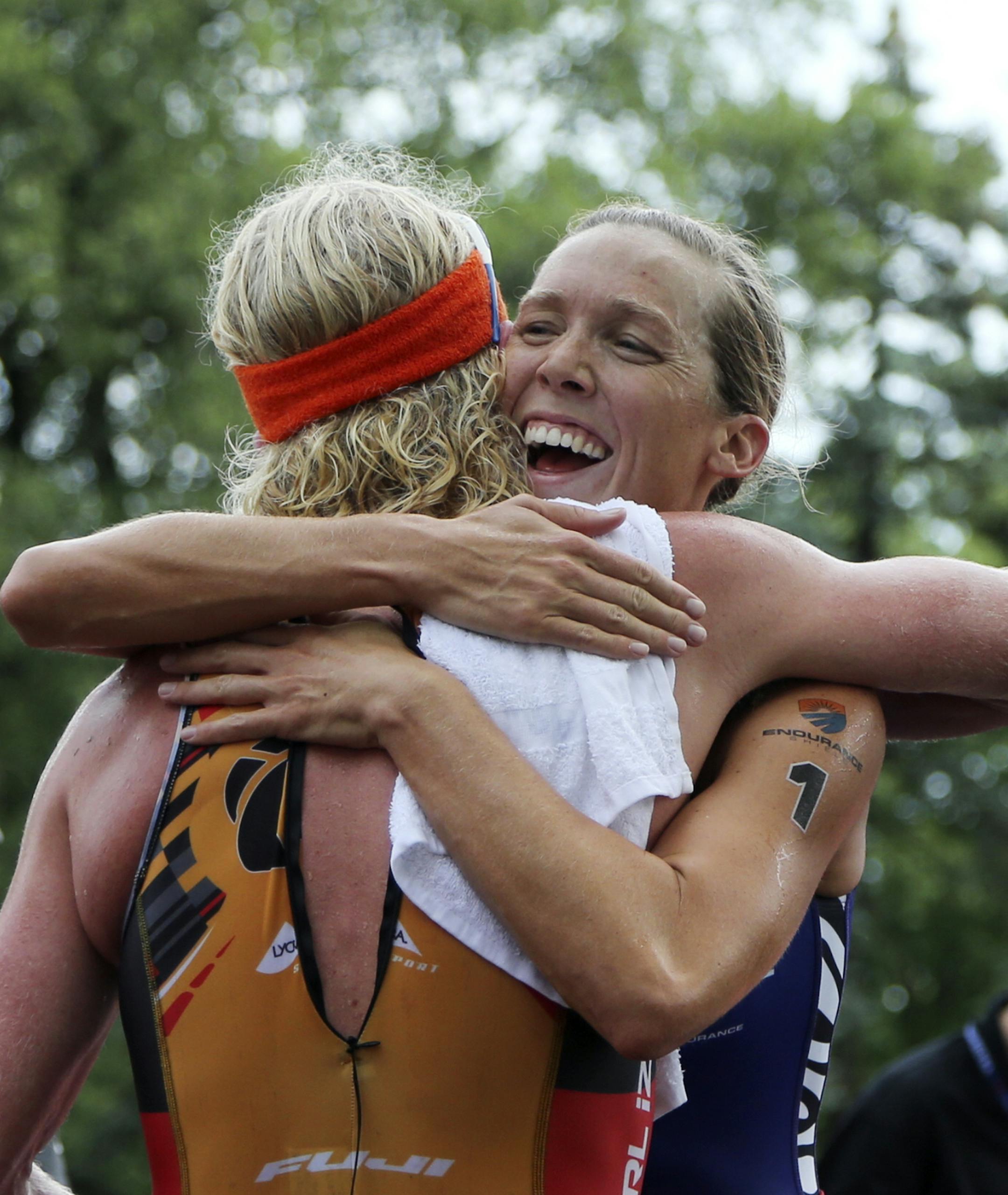 Pro women's winner Alica Kaye, right, embraces the men's pro winner Cameron Dye following the Lifetime Fitness Triathlon at Lake Nokomis Saturday, July 13, 2013, in Minneapolis, MN.](DAVID JOLES/STARTRIBUNE) djoles@startribune.com Lifetime Fitness Triathlon at Lake Nokomis Saturday, July 13, 2013, in Minneapolis, MN.**Alica Kaye, Cameron Dye,cq