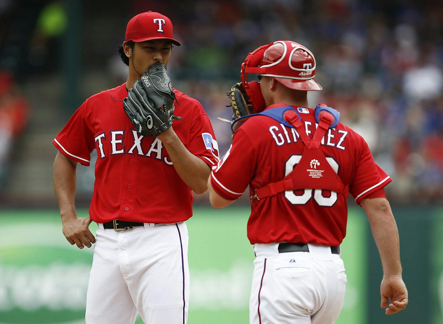 Texas Rangers starting pitcher Yu Darvish and catcher Chris Gimenez meet on the mound during the second inning against the Minnesota Twins on Saturday, June 28, 2014, at Globe Life Park in Arlington, Texas. (Jim Cowsert/Fort Worth Star-Telegram/MCT) ORG XMIT: 1154550