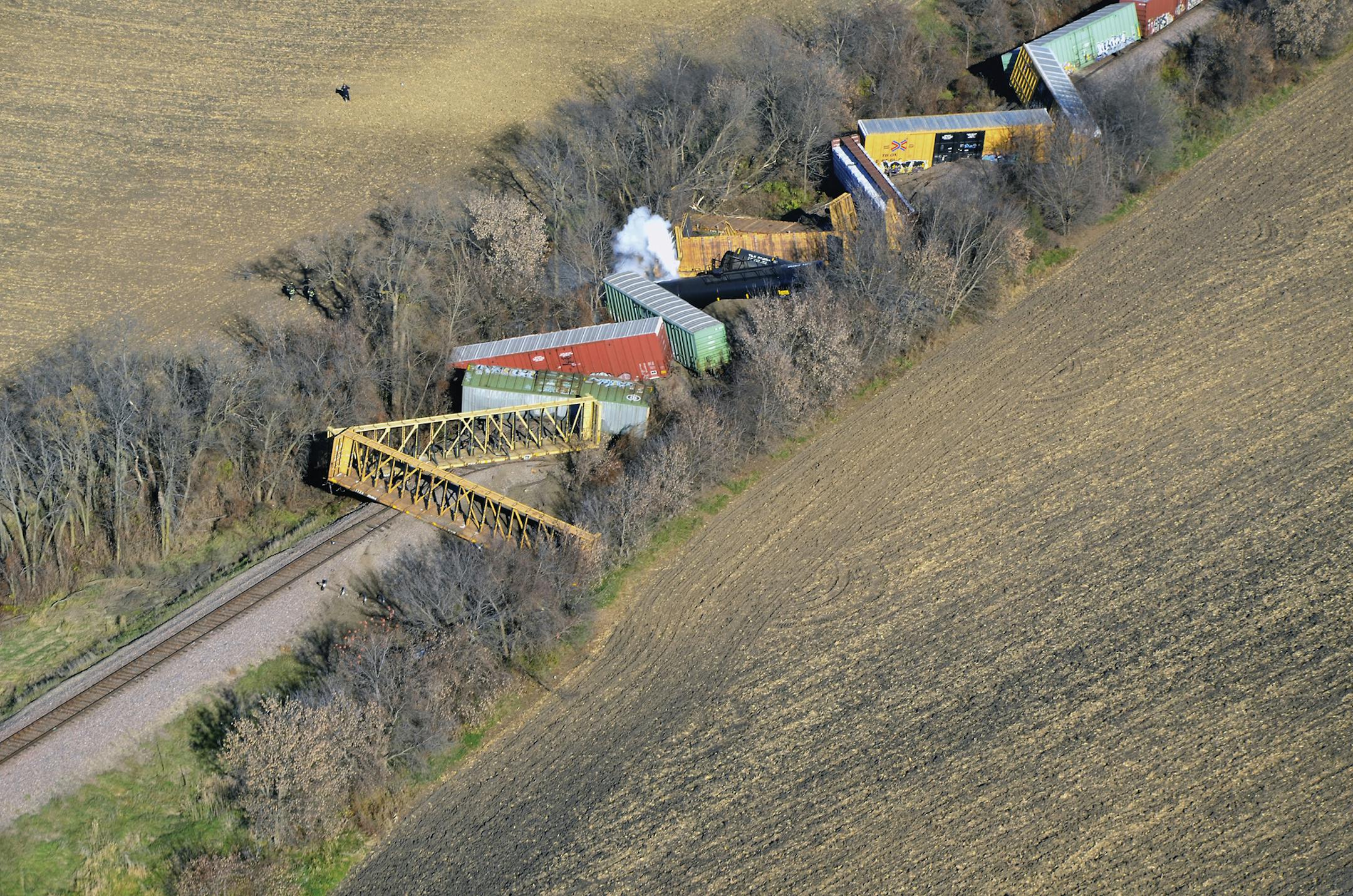 Several cars from a Union Pacific train are seen derailed near Ellendale, Minn., Friday morning, Nov. 11, 2016. The derailment and hazardous chemical spill prompted evacuations in the small southern Minnesota town and the closure of a state highway. No injuries were reported. (Ryan Anderson/The People&#xed;s Press via AP)
