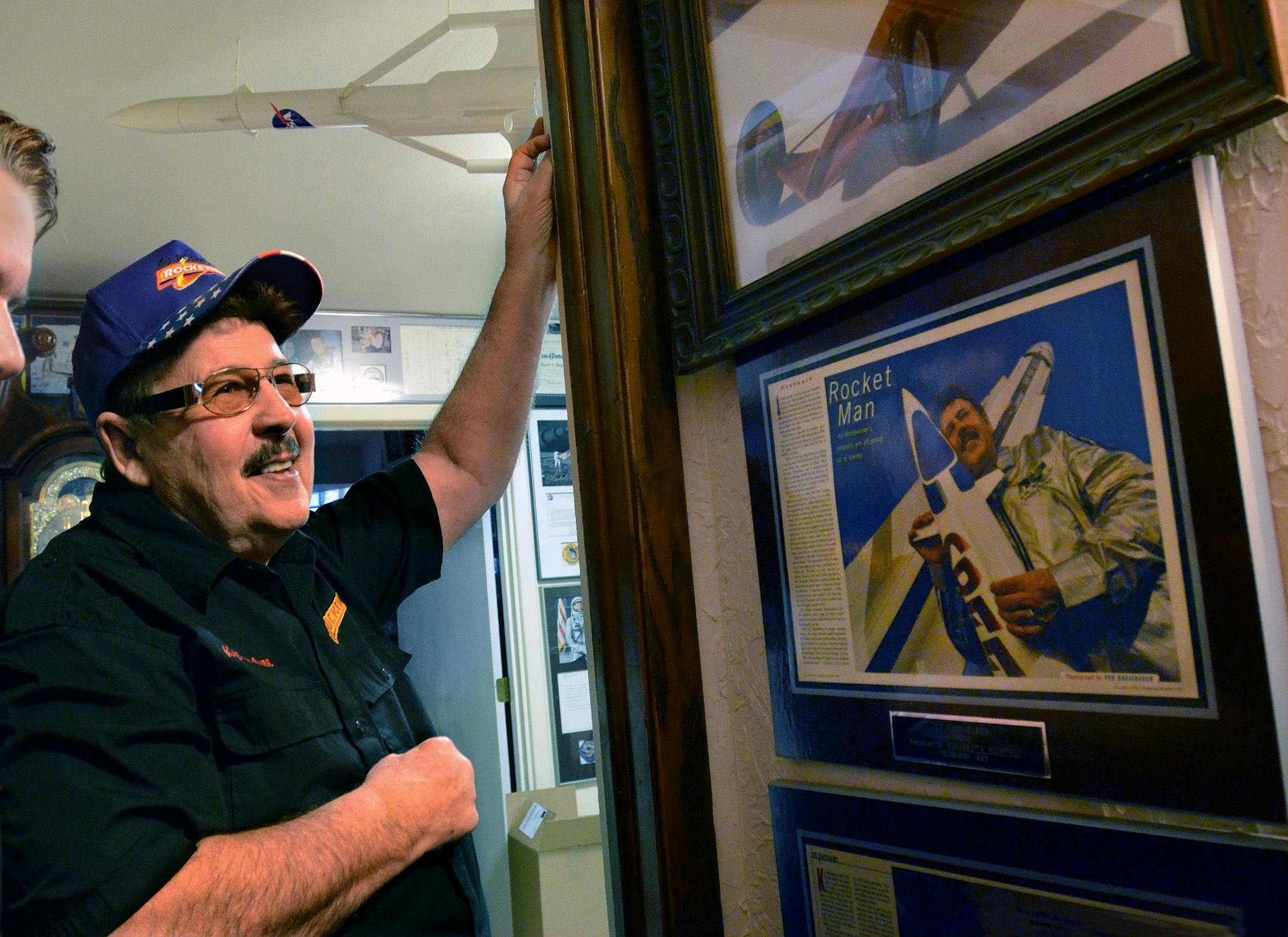 Ky Michaelson (Rocketman) looked over some framed articles on his hallway walls.