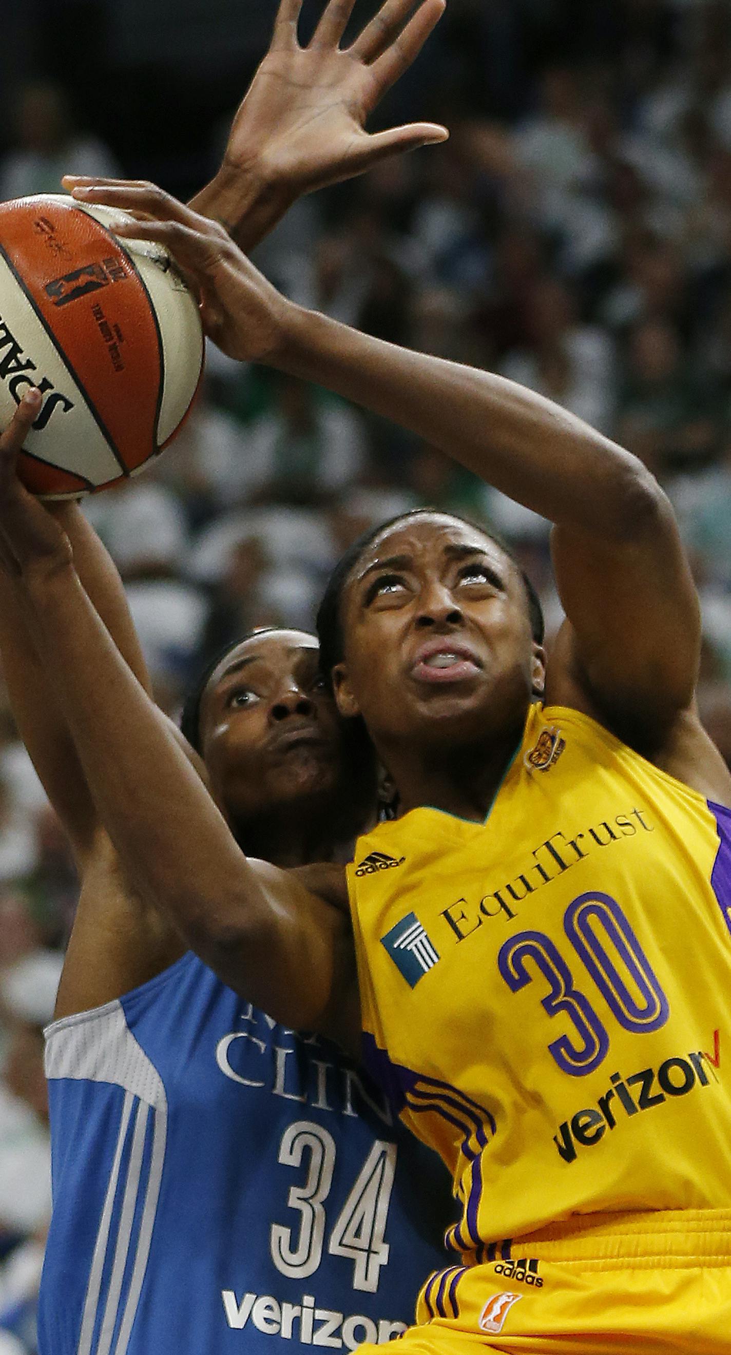 Los Angeles Sparks forward Nneka Ogwumike (30) shoots the ball against Minnesota Lynx center Sylvia Fowles (34) in the first half of Game 1 of the WNBA basketball finals Sunday, Oct. 9, 2016, in Minneapolis. (AP Photo/Stacy Bengs)