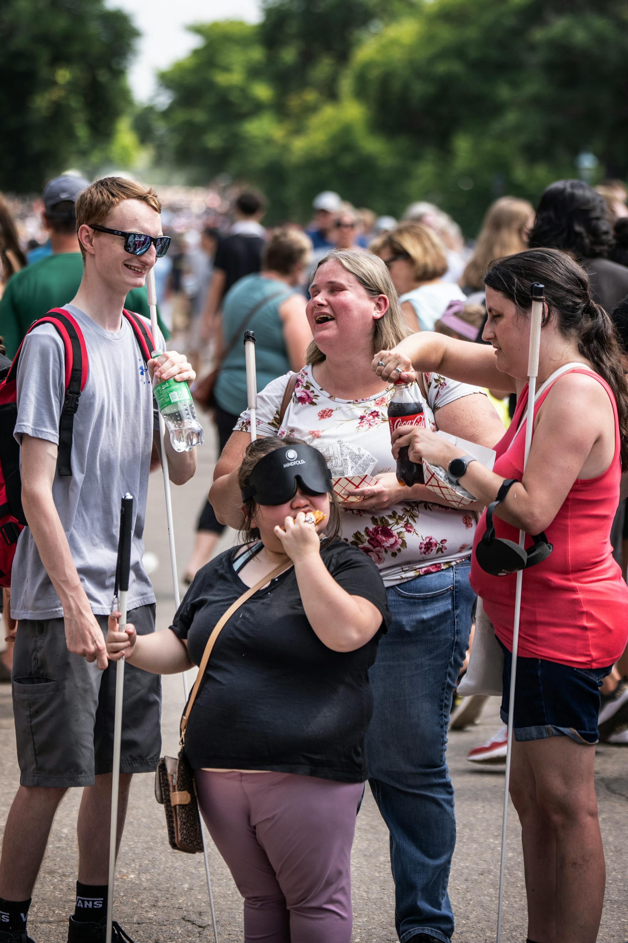 Isabellah Khang 21, a student at the Blind, Inc. in Minneapolis, (front) shared cheese curd tacos with Dillion Kuester, 23, left, Jamie Richey, interim Executive Director, and Chelsey Duranleau, Assistant Director BLIND, Inc. at the Minnesota State Fair.