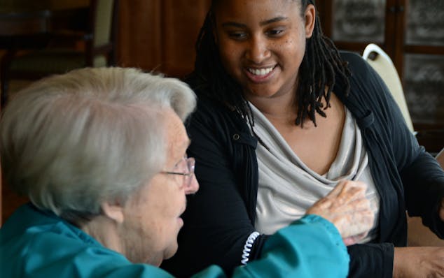 (Left to right) Virginia Bourgeois played a card game called Skip Bo with Activity Assistant Sanika Brown in Gardenview at York Gardens (Ebenezer's se