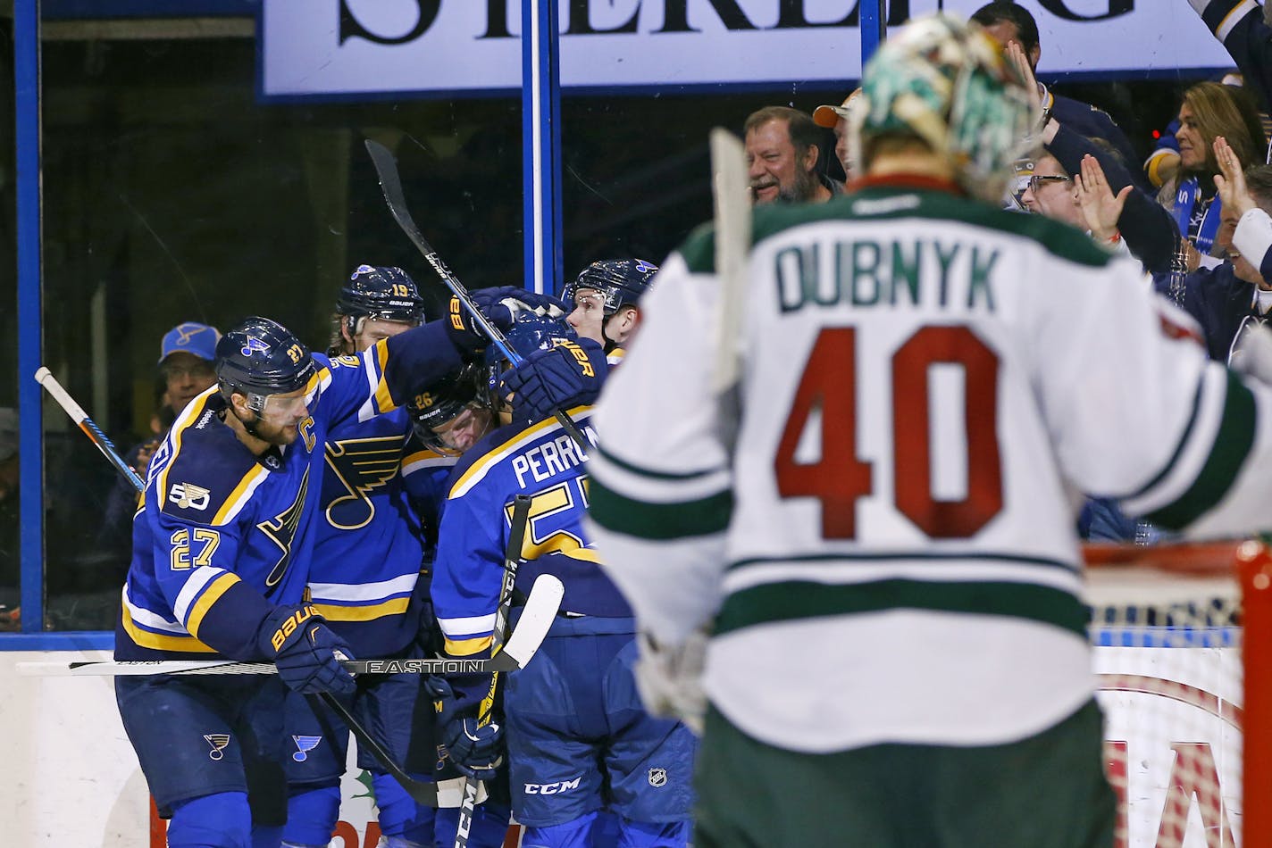 Minnesota Wild goalie Devan Dubnyk (40) reacts as St. Louis Blues' Paul Stastny (26) is congratulated by teammates Alex Pietrangelo (27), Jay Bouwmeester (19), and David Perron (57) after scoring a goal during the second period of an NHL hockey game Saturday, Nov. 26, 2016, in St. Louis. (AP Photo/Billy Hurst)