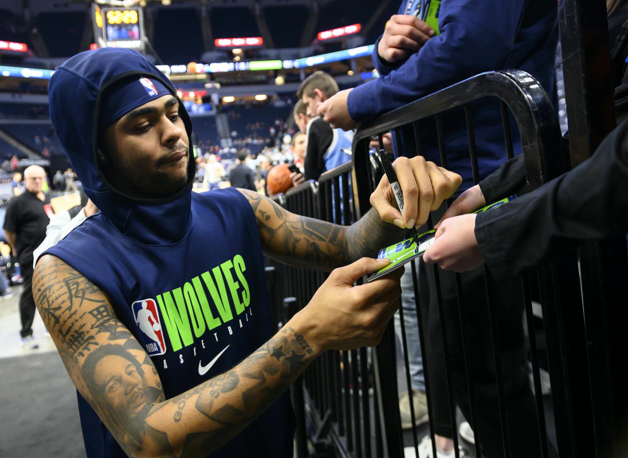 Timberwolves guard D'Angelo Russell (0) signed autographs for fans before a game in February.